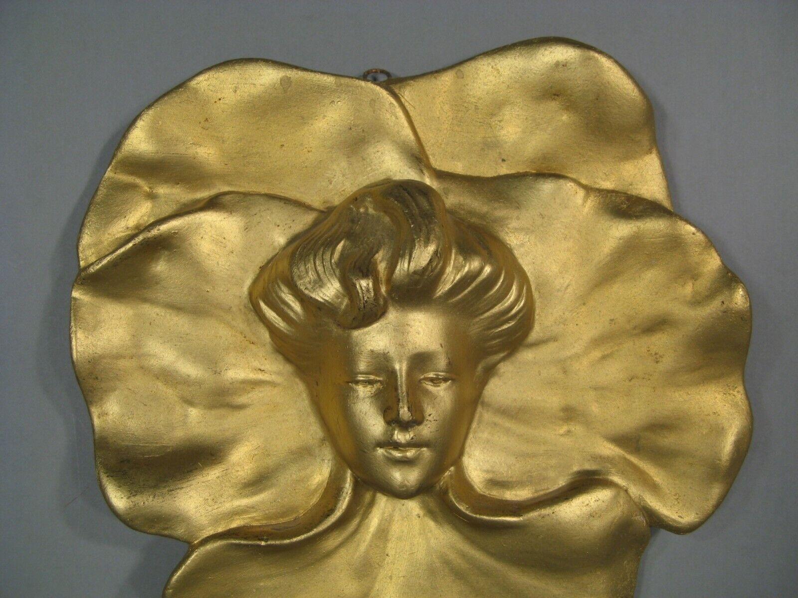 Immerse yourself in the elegance of the Art Nouveau era with this stunning antique terracotta bas-relief. This large wall hanging features a beautifully detailed mask of a young woman, epitomizing the graceful and organic aesthetic of the early 20th