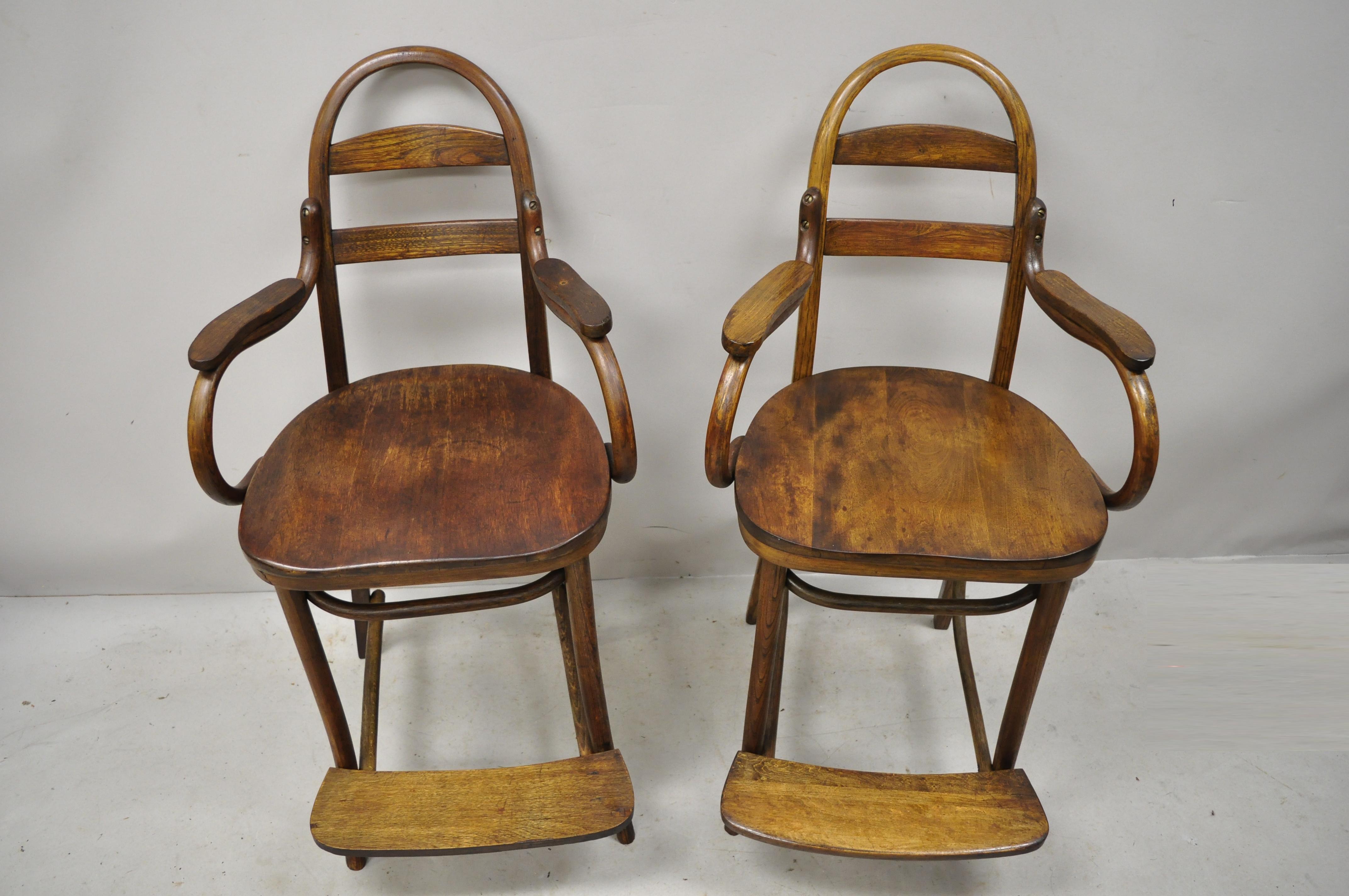 Antique Art Nouveau Thonet style Austrian bentwood counter stool chairs, a pair (Slight variation in stretcher bases and armrests). Item features bentwood frames, slat backs, footrests, very nice antique item. Slight variation in stretcher bases and