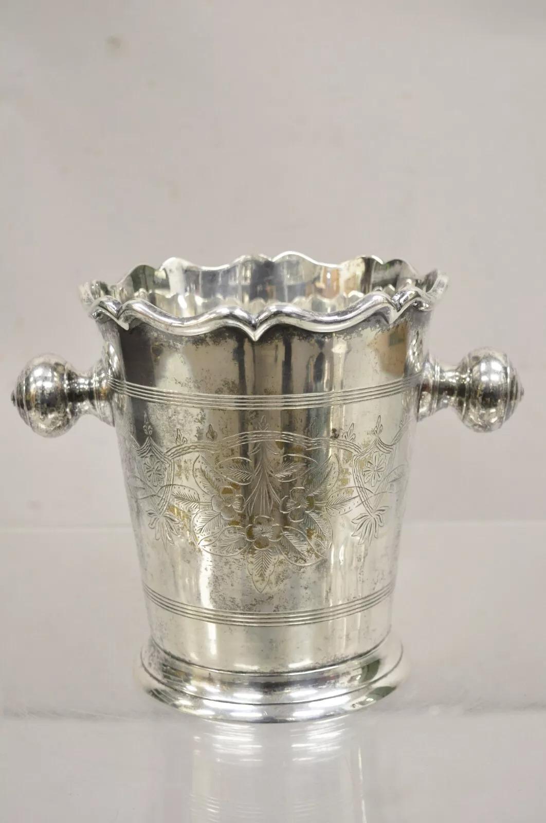 Antique Kent Silversmiths Art Nouveau Twin Knob Handle Silver Plated Champagne Chiller Ice Bucket. Item features floral scrollwork etched design, scalloped rim, ornate twin knob handles, very nice vintage chiller. Circa Early 20th Century.