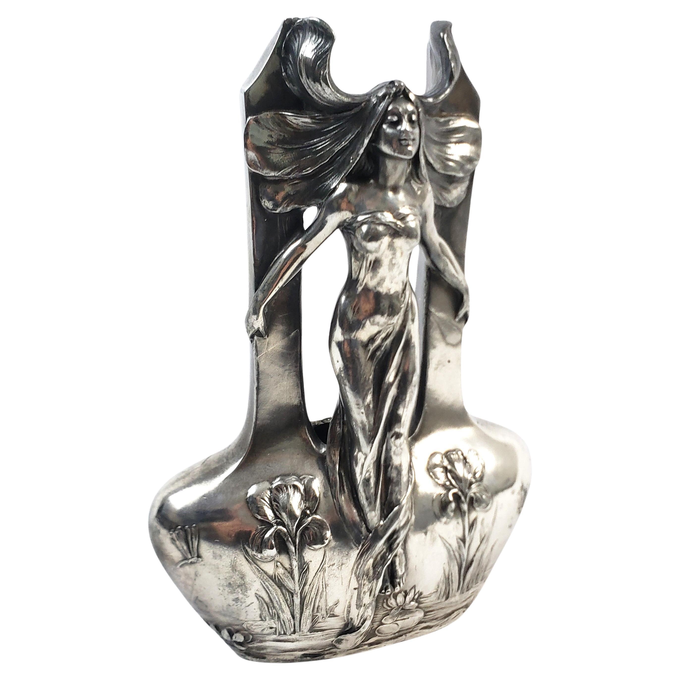 This antique vase is unsigned but presumed to have originated from the United States and date to approximately 1900 and done in the period Art Nouveau style. The vase is composed of plated spelter and depicts a stylized female with flowing hair