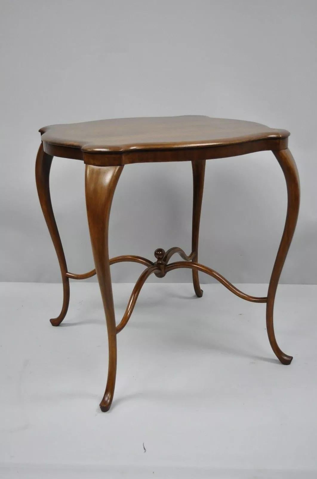 Antique Art Nouveau Victorian Mahogany Turtle Top Cabriole Leg Side Table. Item features arched and shaped stretcher with ball form finial, shaped turtle top, beautiful wood grain, cabriole legs, great style and form. Circa Early 20th Century.