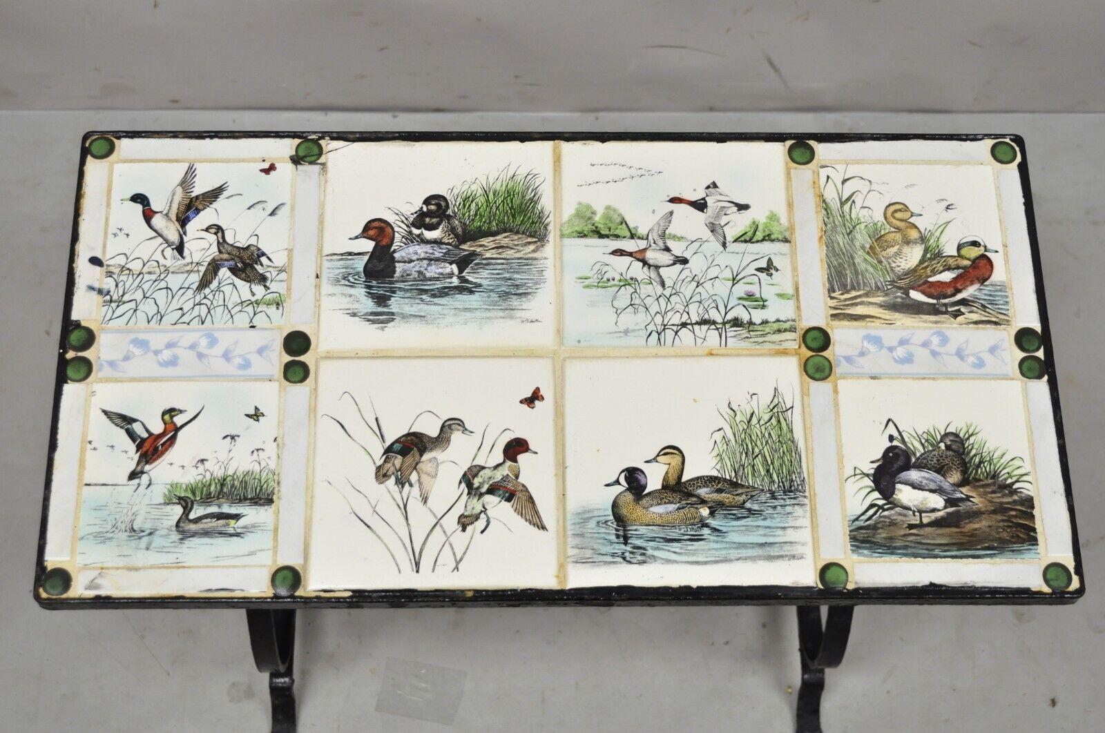 Antique Art Nouveau wrought iron small side table with duck geese tile top. Item features (8) Porcelain/ceramic decorative tiles with various duck/geese scenes, black wrought iron base, very nice antique item, great style and form, tiles signed by