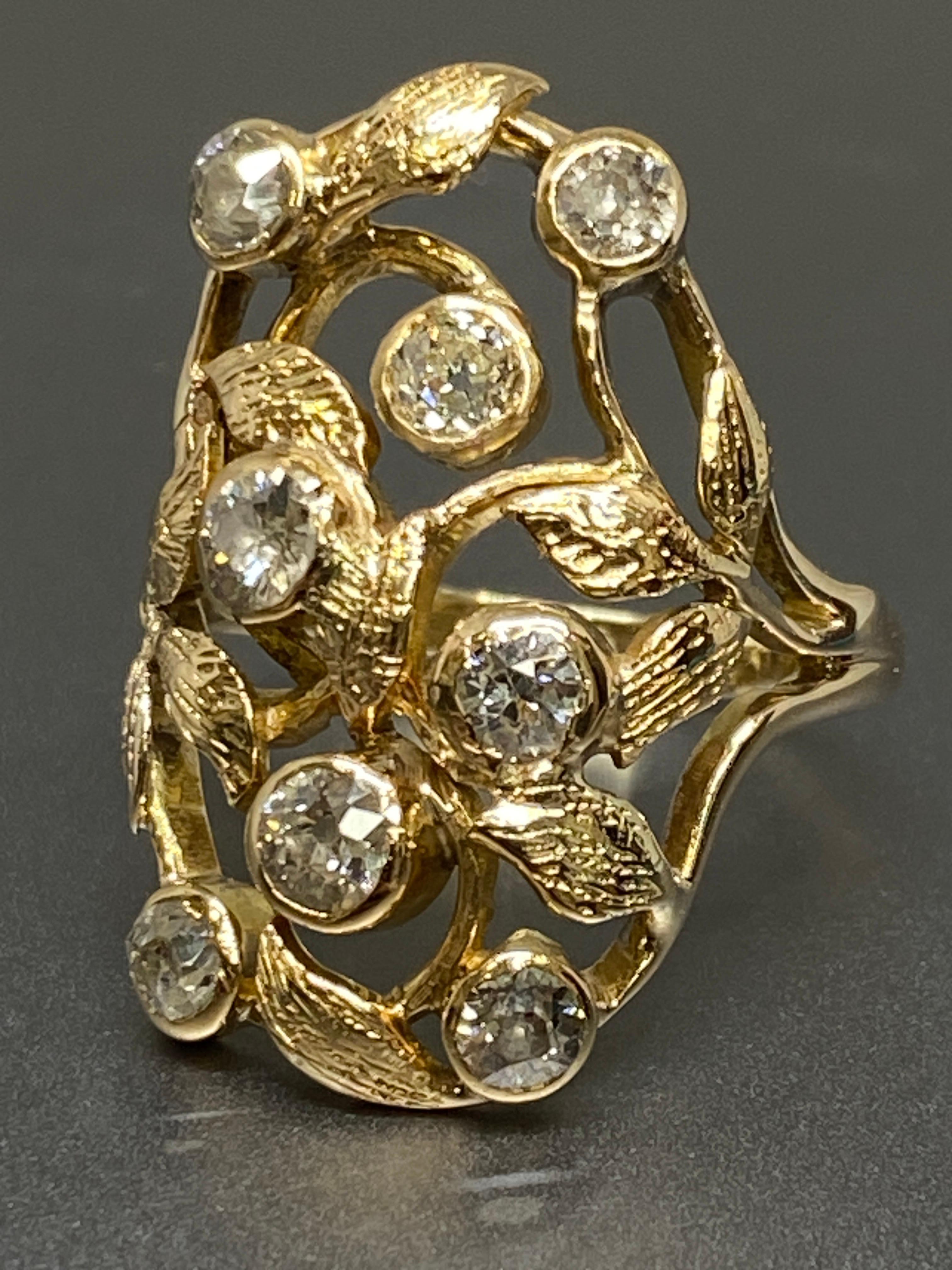 Up for your consideration we have this sublime nature-inspired ring dating back to the turn-of-the-twentieth century - circa 1900. 

A cluster of bright-white old european cut sparkling diamonds together weighing 1.10 carat, are nestled between
