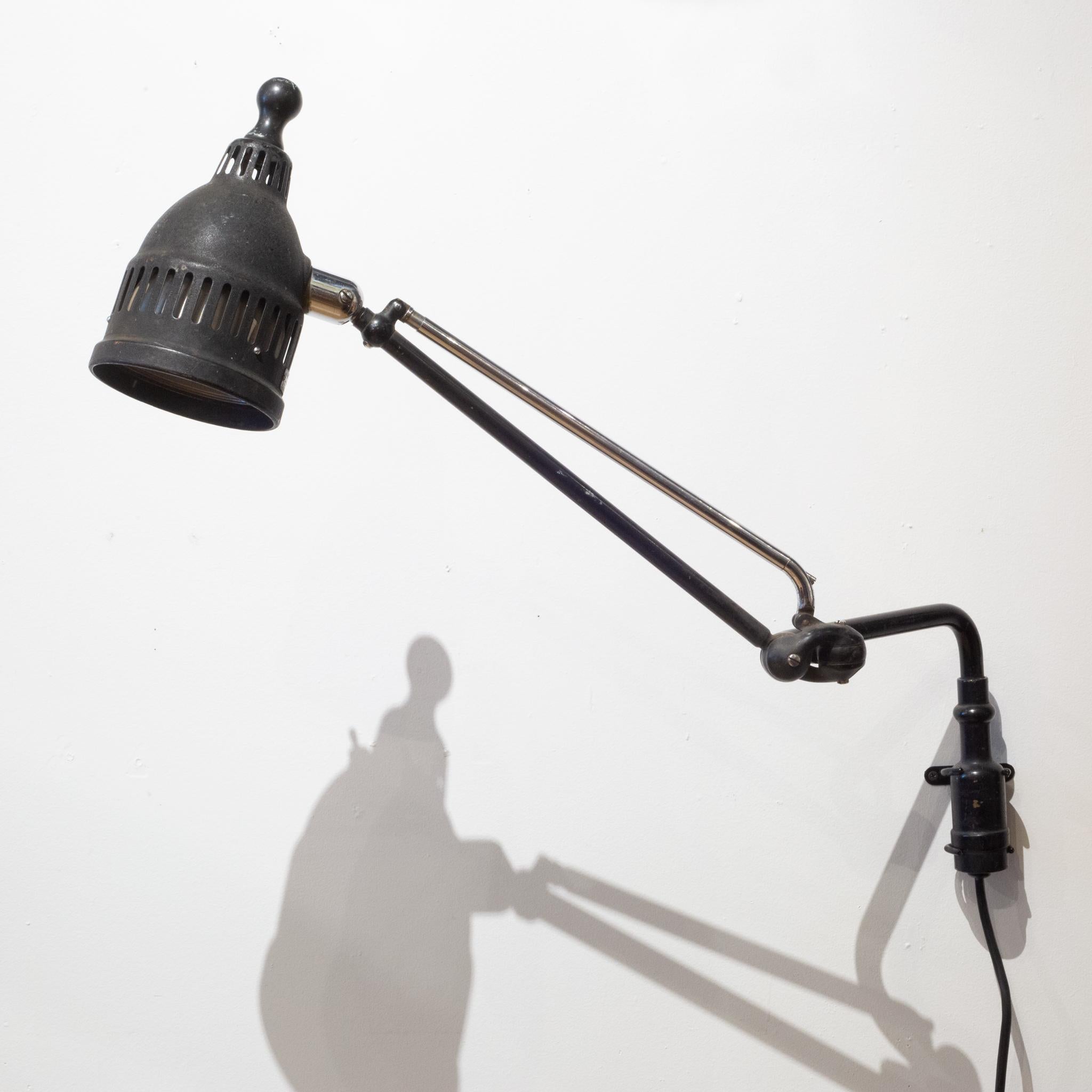 About

An original articulating Ritter Dualite dental light with metal shade and chrome and metal arm. The shade is metal with a wooden handle. The light swivels at the base and adjusts on the arm and shade. A custom steel wall mount has been