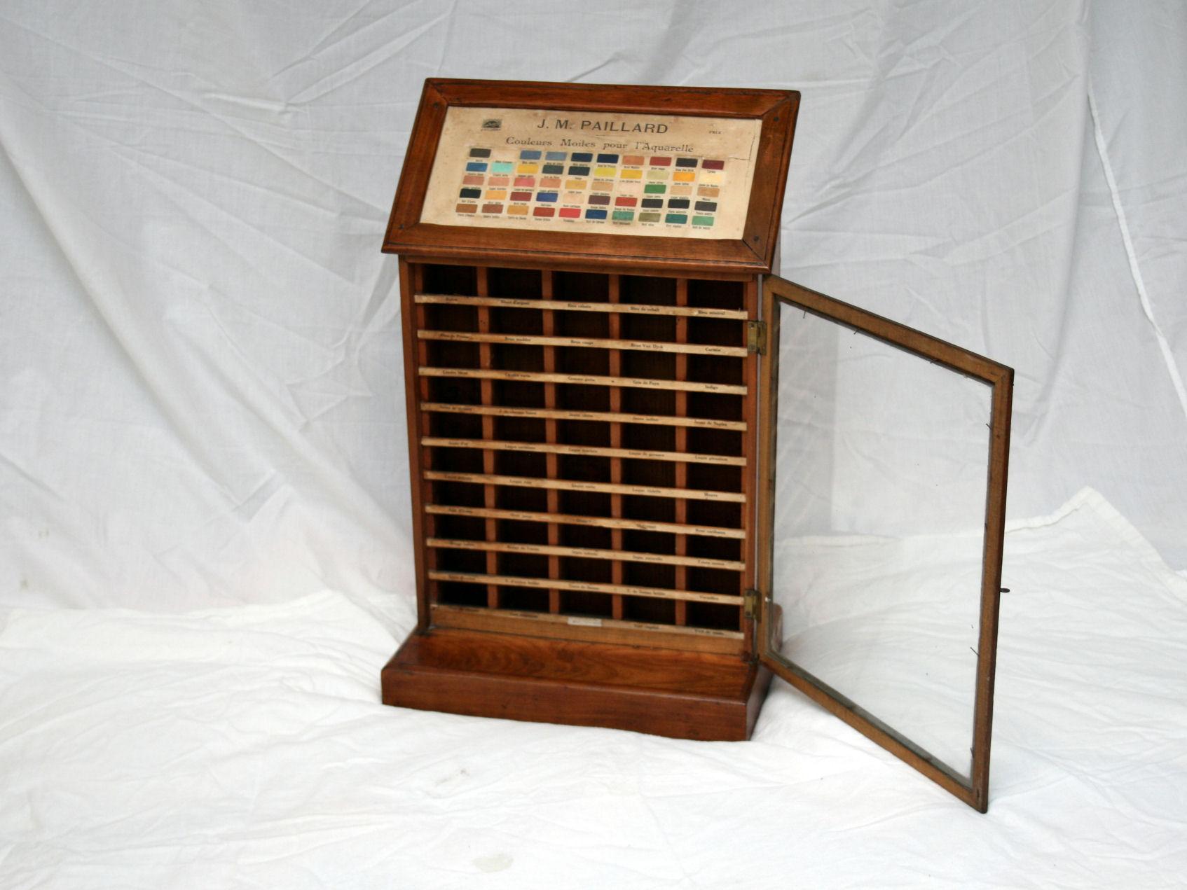 Fabulous and rare, this is a counter-top display case made from fruitwood was used to display a range of paint colors for J Paillard Artist Paints.
The front door opens and this is where the blocks of paint would have been stored.

In Excellent