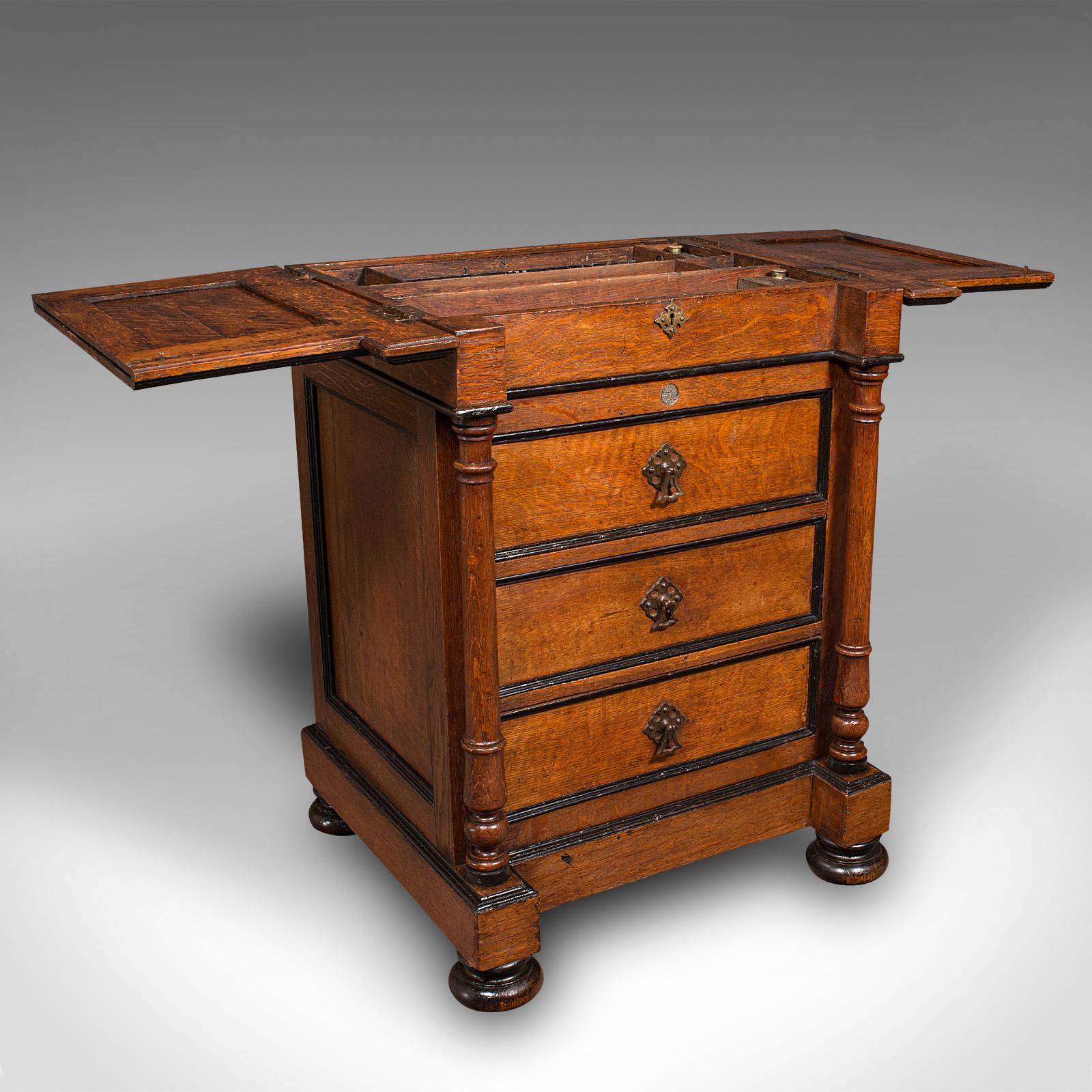 This is an antique artist's materials table. An English oak fold out companion stand by Roberson & Co of London, dating to the mid Victorian period, circa 1870.

Extraordinary artist's table by the renowned paint specialists C. Roberson &