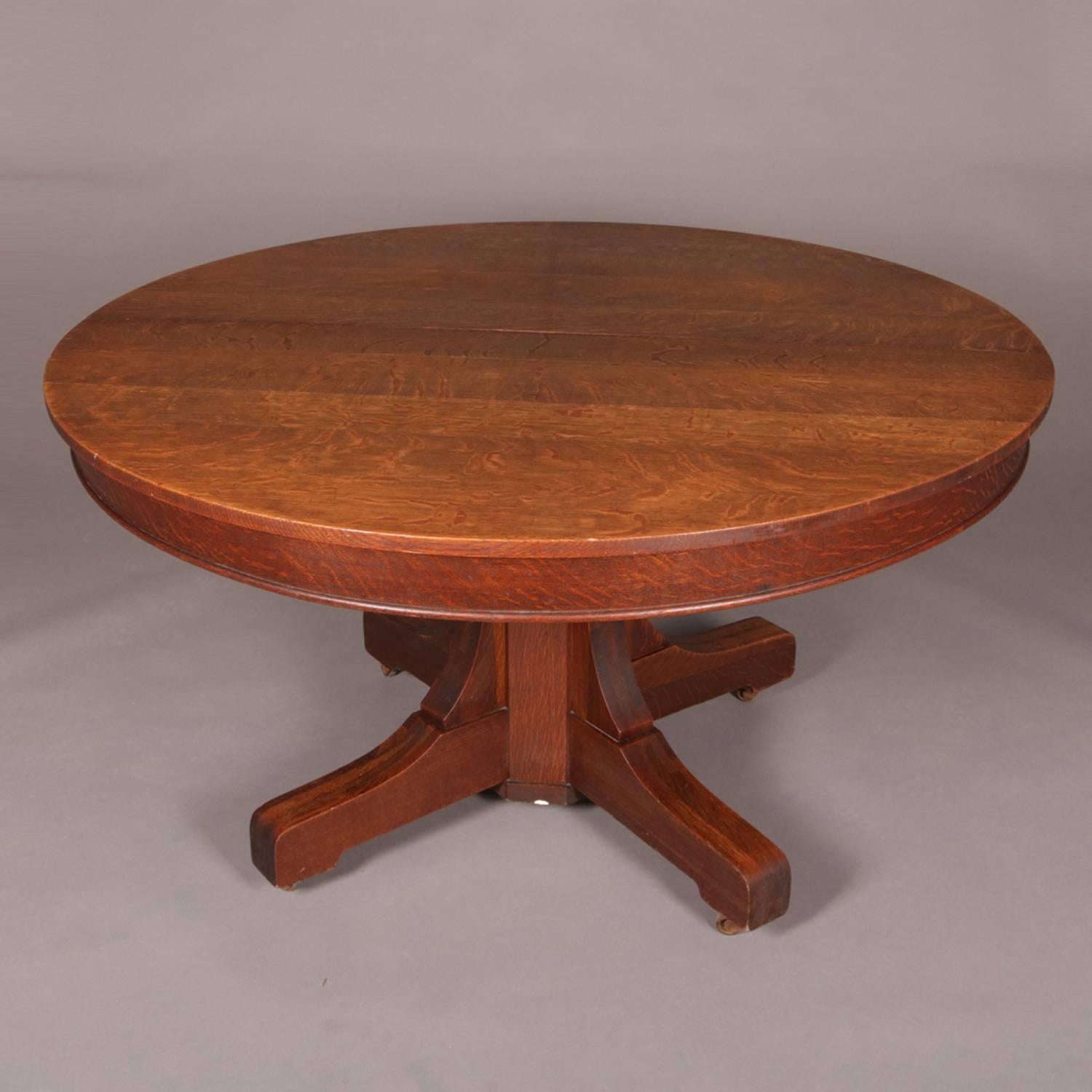 Antique Arts & Crafts mission oak dining table by Hastings features pedestal base with four legs, expands to accommodate three 9