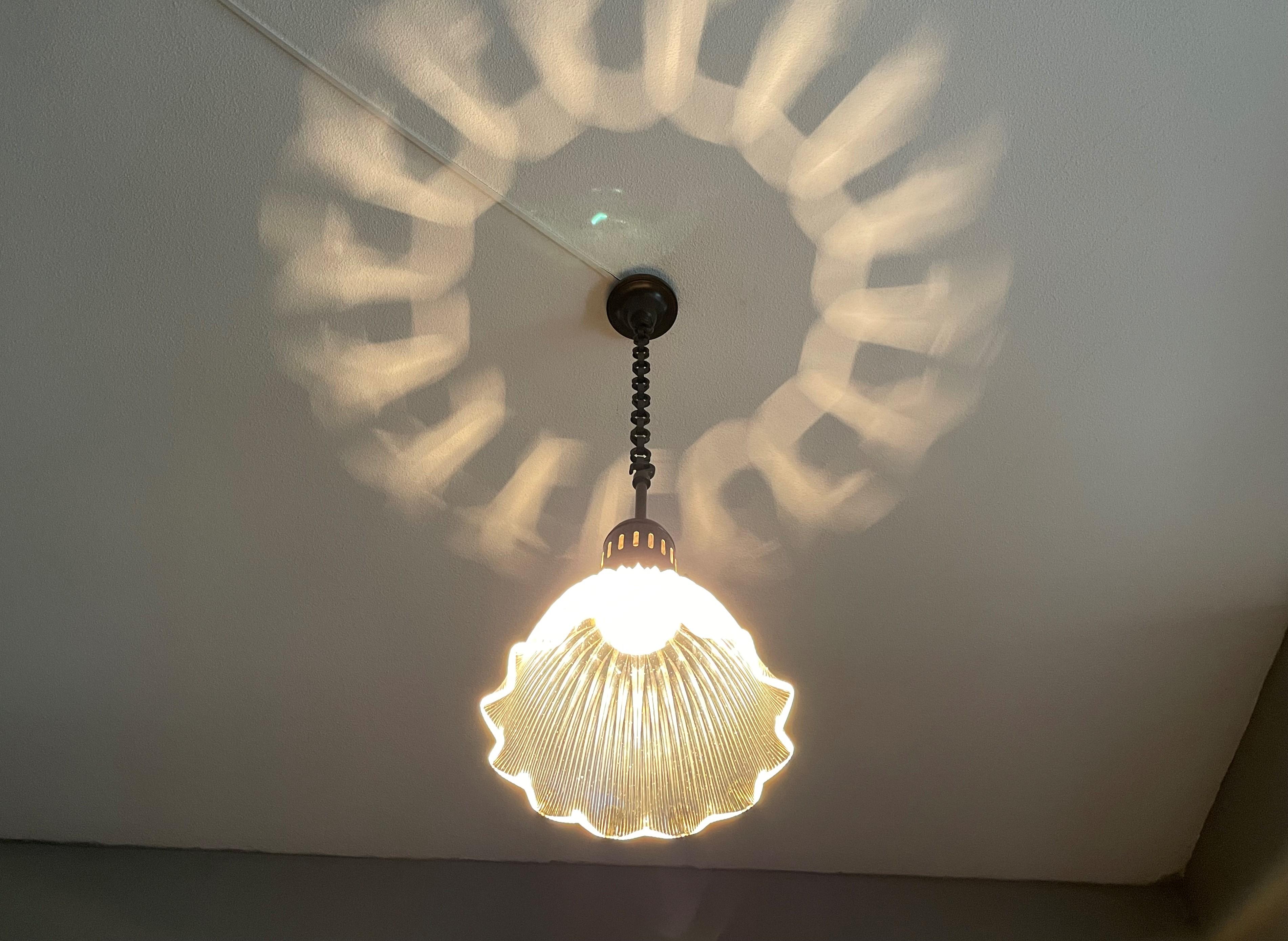 Stylish, timeless and completely original antique pendant by Holophane, France.

If you are looking for the ideal pendant to light up your entrance, hallway, writing table, desk or maybe a small room then this antique brand name fixture could be