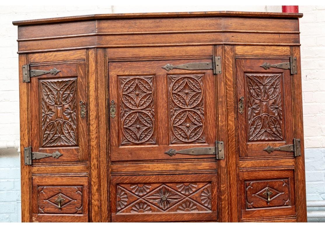 A very well made and finely carved Cabinet from the Estate of Multidisciplinary Artist Norma Flanagan. An angular cabinet with two wings flanking the projecting center cabinet. With top and lower carved panels with either four rosettes in circles or