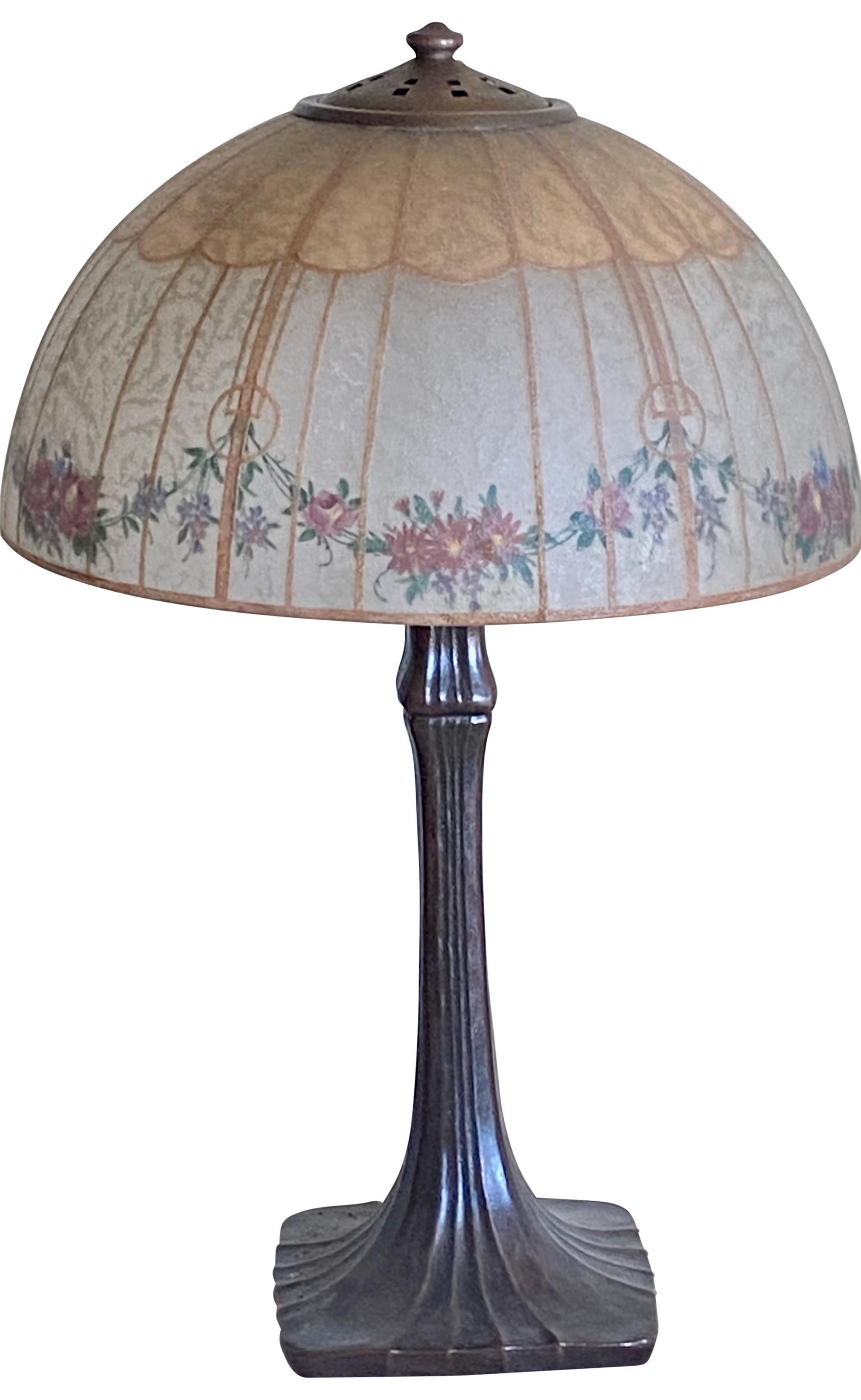 American Arts and Crafts period Handel table lamp (c1910-15) with original reverse hand painted glass shade. 
Signed Handel on shade, top brass ring and also on the base.  
In excellent original antique condition.
Recently rewired.