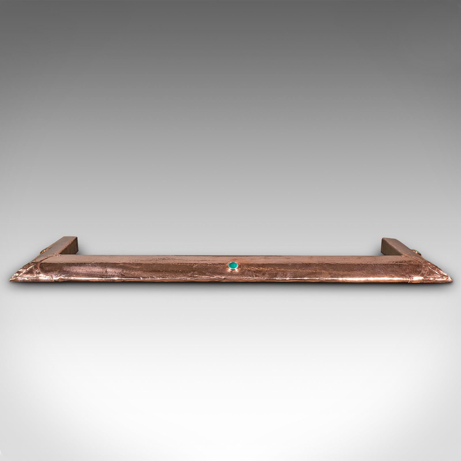 This is an antique Arts and Crafts fire kerb. An English, copper fireside surround with Ruskin-esque cabochon, dating to the late Victorian period, circa 1890.

Elegant fire kerb with appealing Arts & Crafts movement taste
Displays a desirable