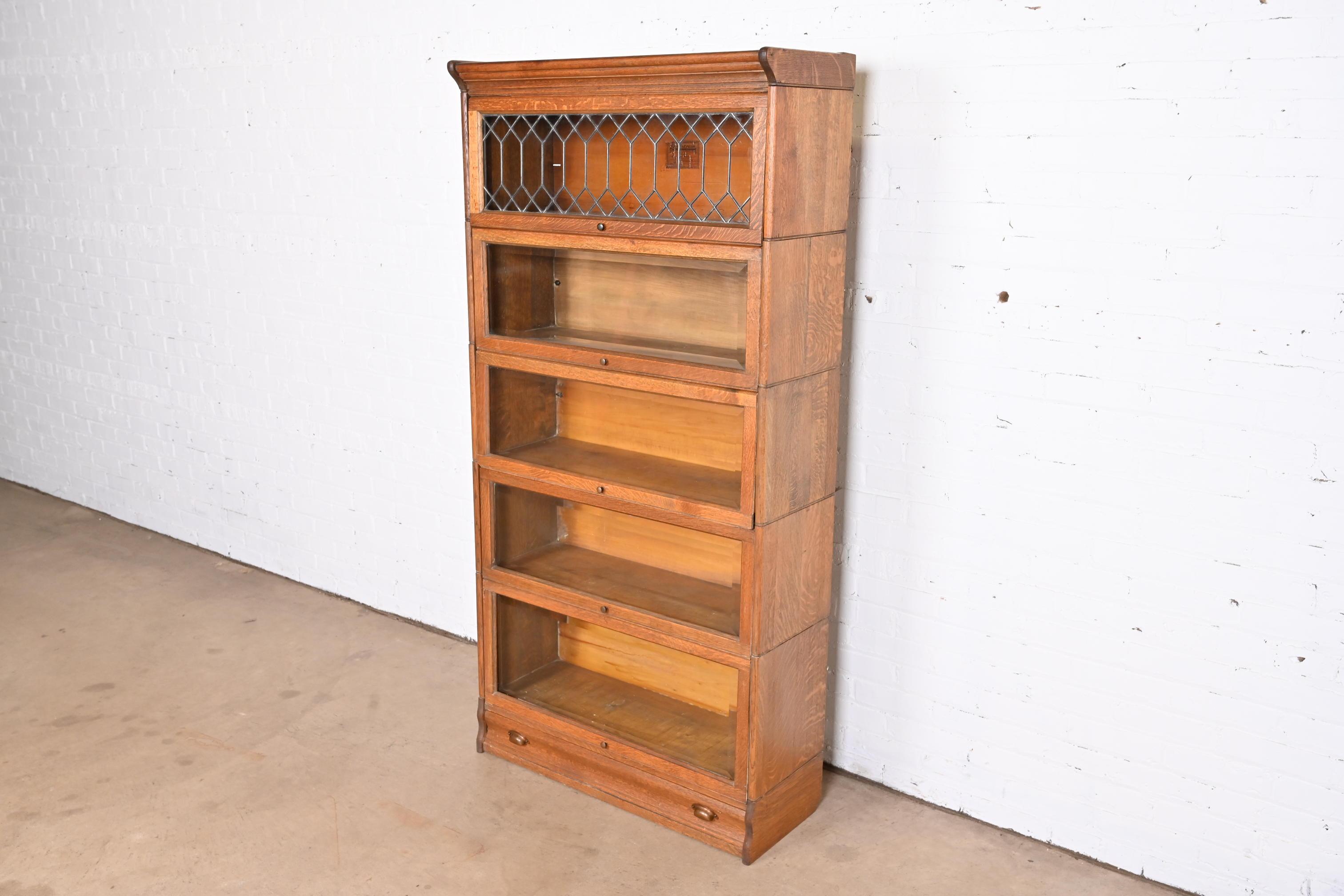 A gorgeous antique Arts & Crafts five-stack barrister bookcase with leaded glass

By Lundstrom

USA, Circa 1900

Quartersawn oak, with glass front doors and original brass hardware.

Measures: 33.75