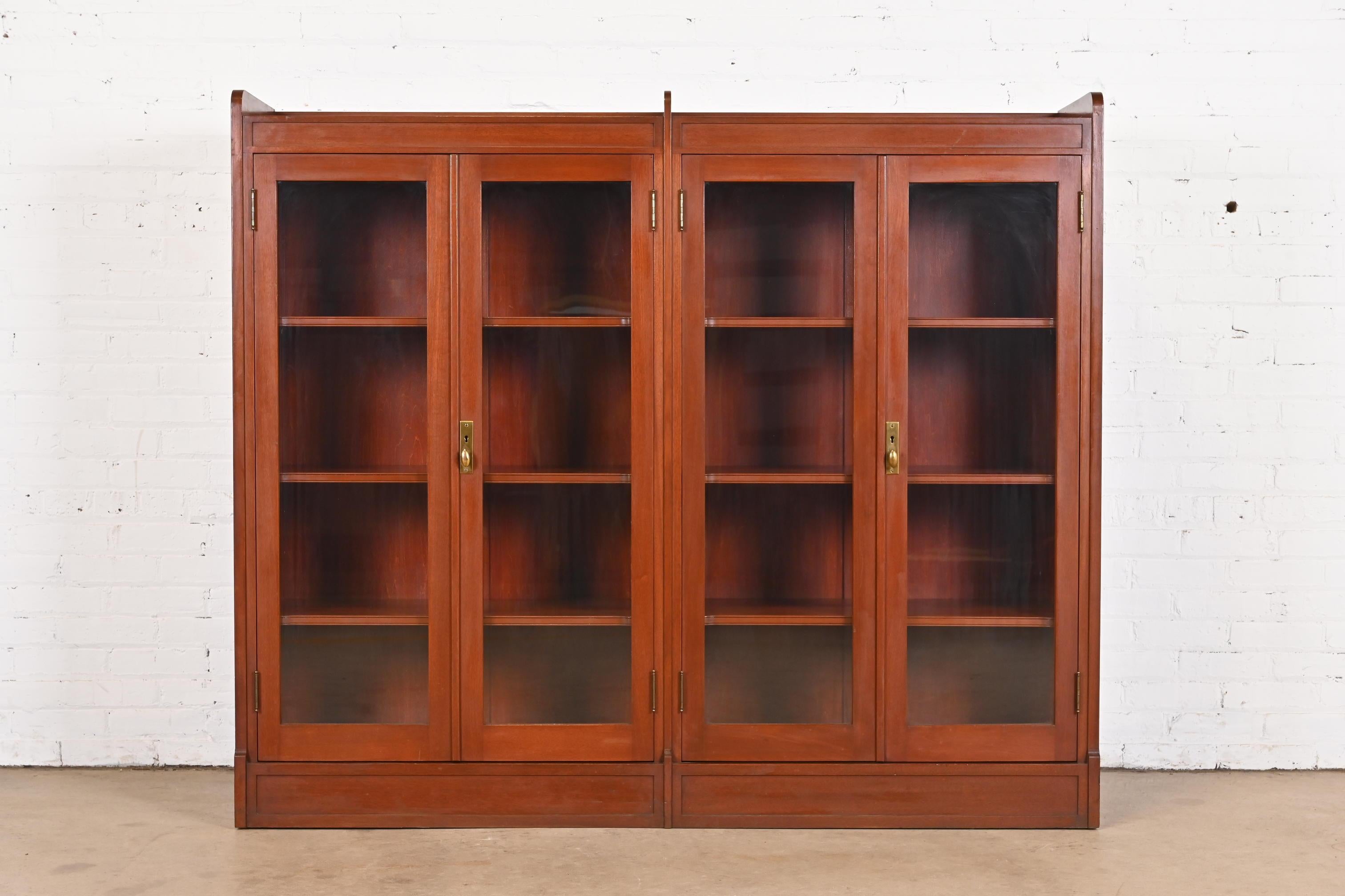 A gorgeous antique Arts & Crafts four-door double bookcase

In the manner of Stickley

USA, Circa 1920s

Solid mahogany, with glass front doors, and original brass hardware.

Measures: 66