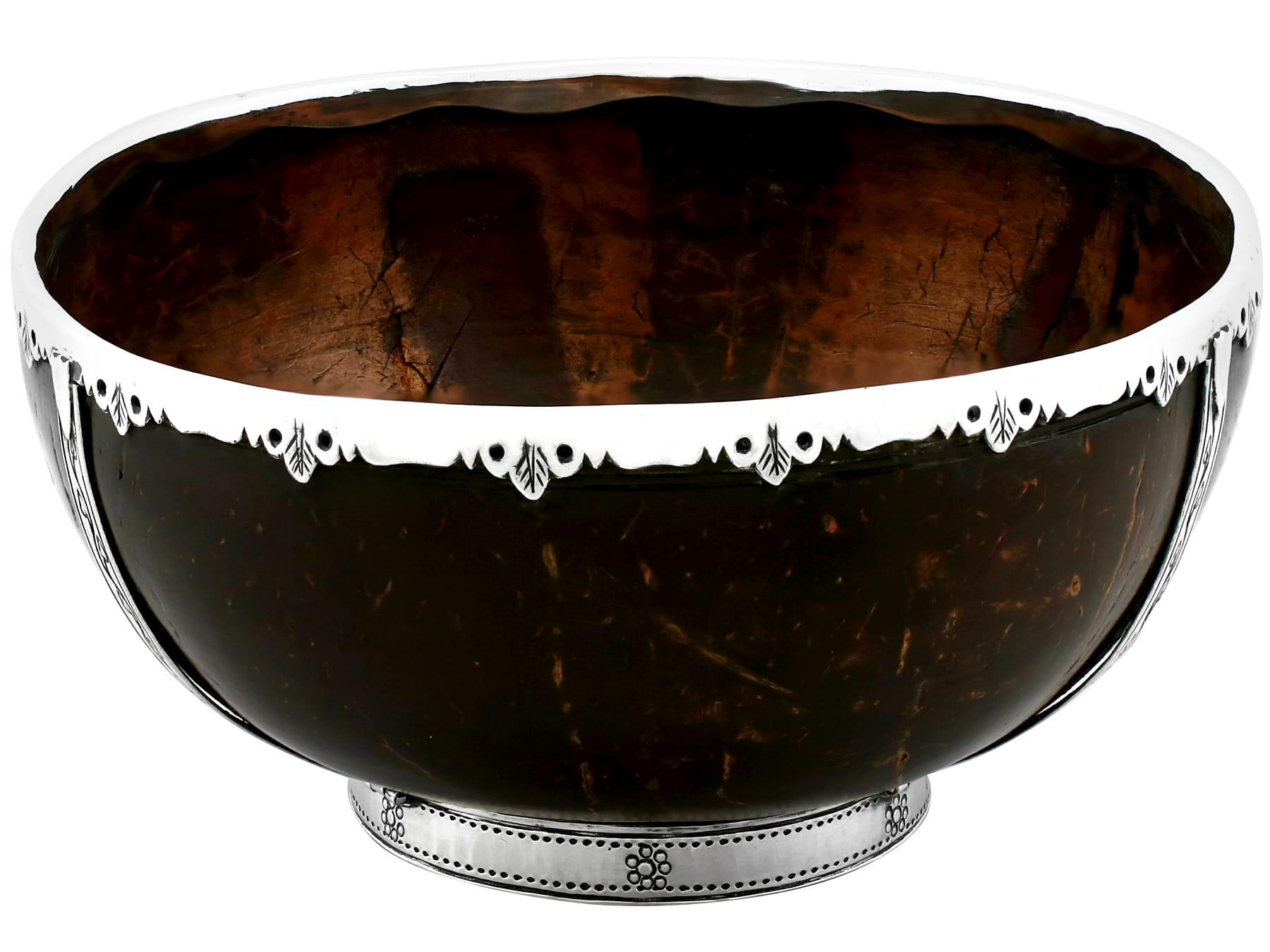 An exceptional, fine and impressive antique English sterling silver mounted coconut cup; an addition to our diverse silverware collection.

This exceptional antique George V sterling silver mounted coconut bowl has a circular rounded form onto a