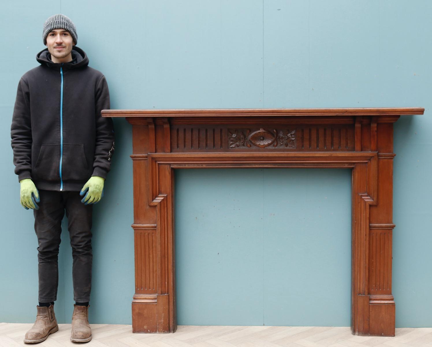 A fire surround in the Arts and Crafts style with carved jambs. The frieze depicts foliage and swags.

Additional dimensions 

Opening height 96.5 cm

Opening width 101.5 cm

Width between outsides of the foot blocks 148 cm.