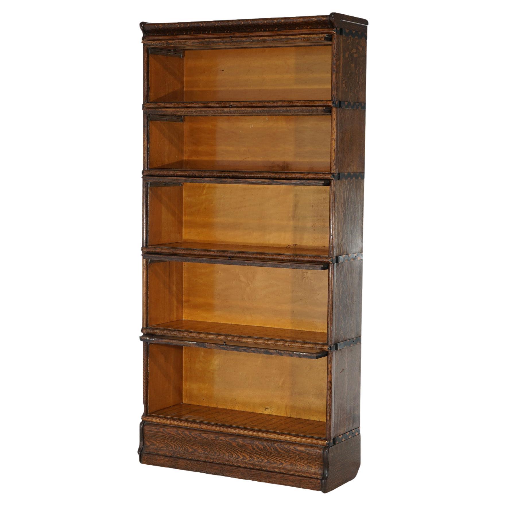 An antique Arts and Crafts barrister bookcase attributed to Globe Wernicke or Macey offers quarter sawn oak construction with five stacks, each having pull-out glass doors, raised on an ogee base, c1910

Measures - 70.75