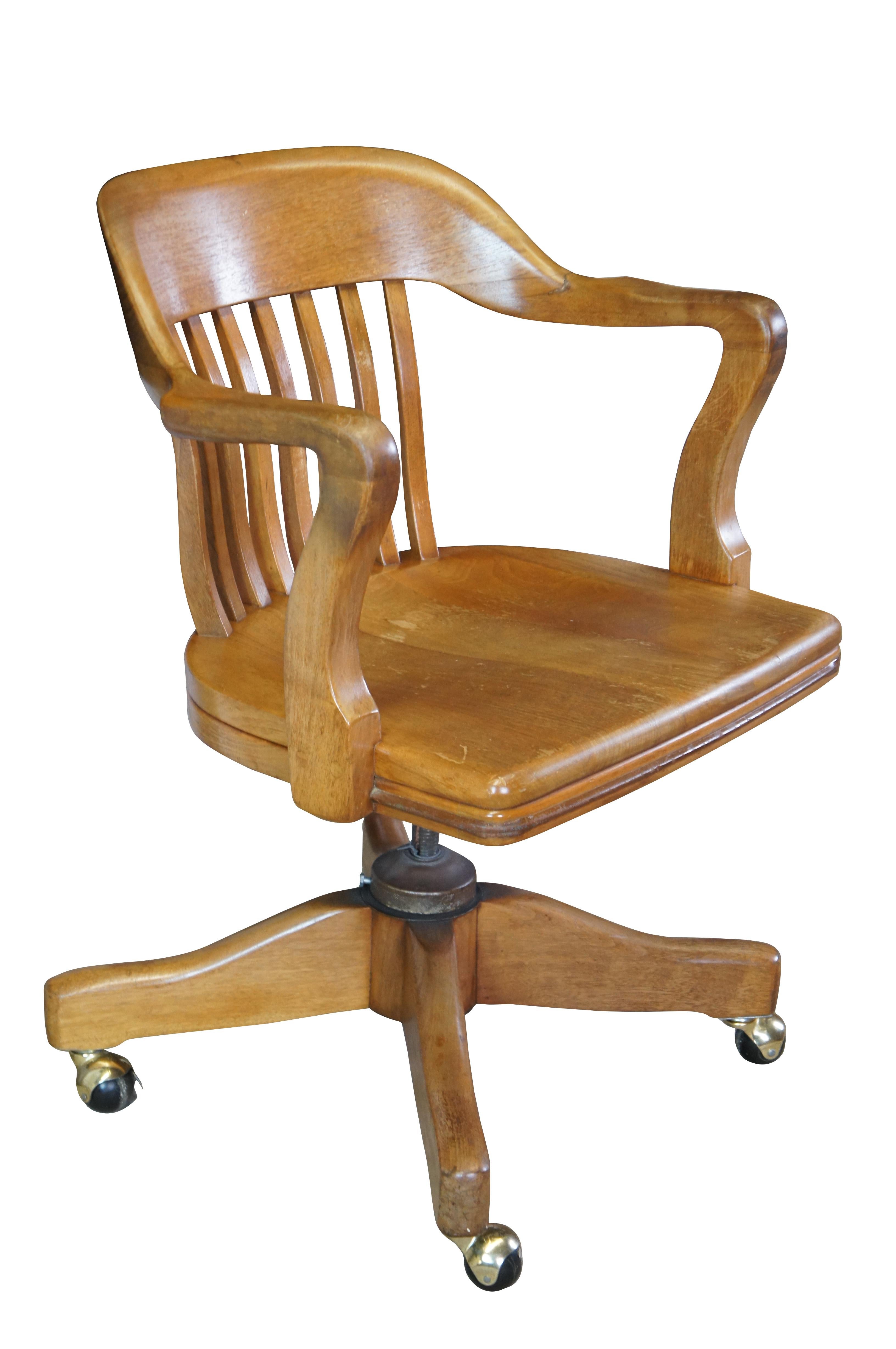 Early 20th Century Antique American Walnut Library Lawyers Desk Chair, circa 1930s.  Features a curved back, contoured seat, swivel / leaning mechanism and wheels for ease of moving.  The chair is meant to have an adjustable height but currently has