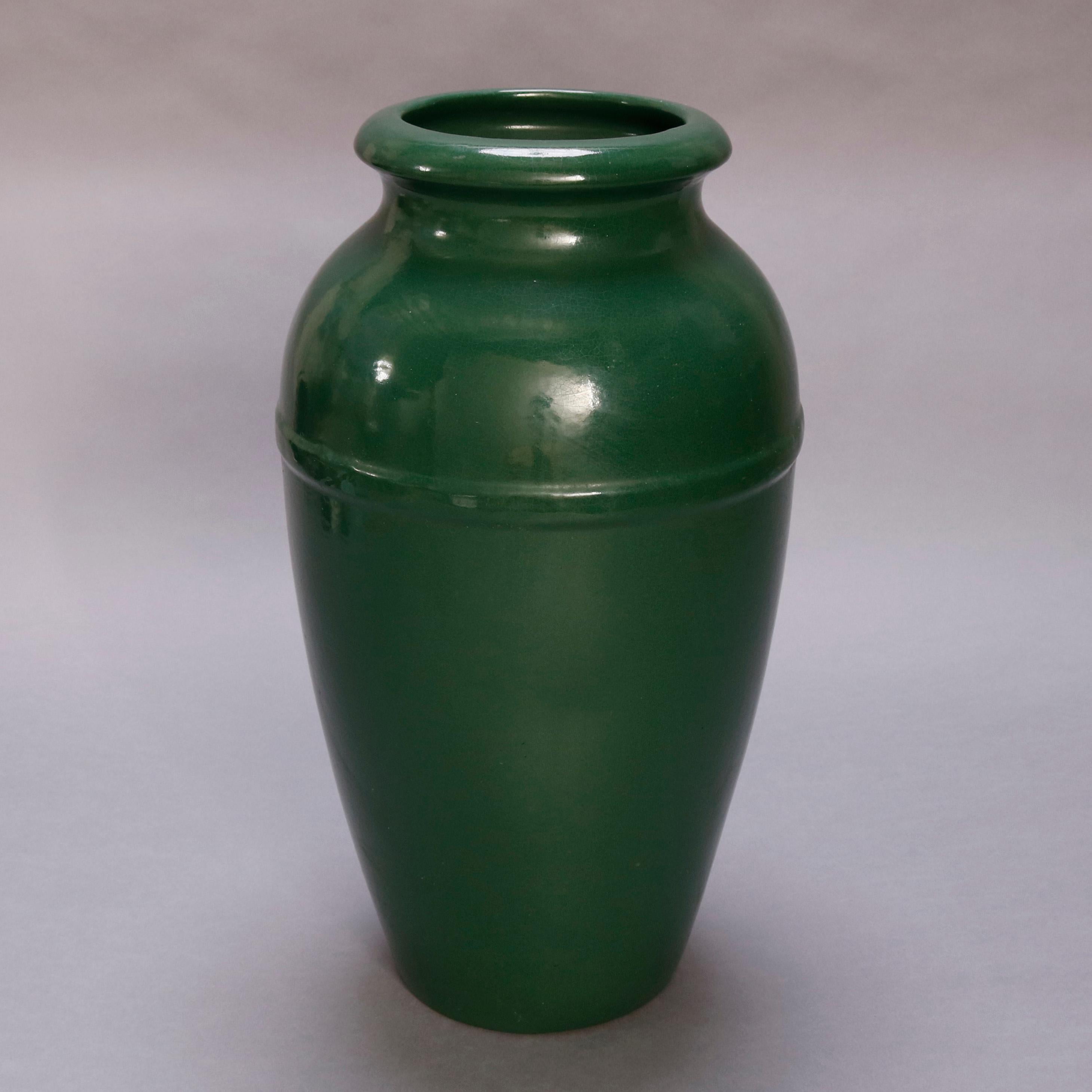 An Arts & Crafts art pottery floor vase by Roseville offers open urn form in pattern #294 with green glaze, base incised 