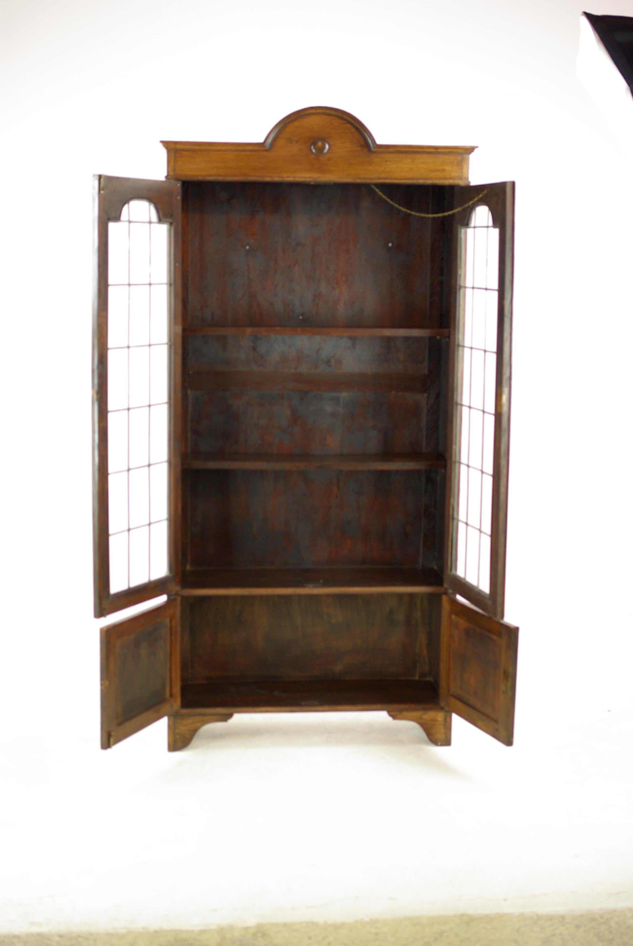 Antique Arts & Crafts bookcase, oak bookcase, leaded glass, antique furniture, B1203

Scotland, 1910
Solid oak
Original finish
Half moon cornice
Pair of original leaded glass doors
Fitted with three solid wooden adjustable shelves
Two door