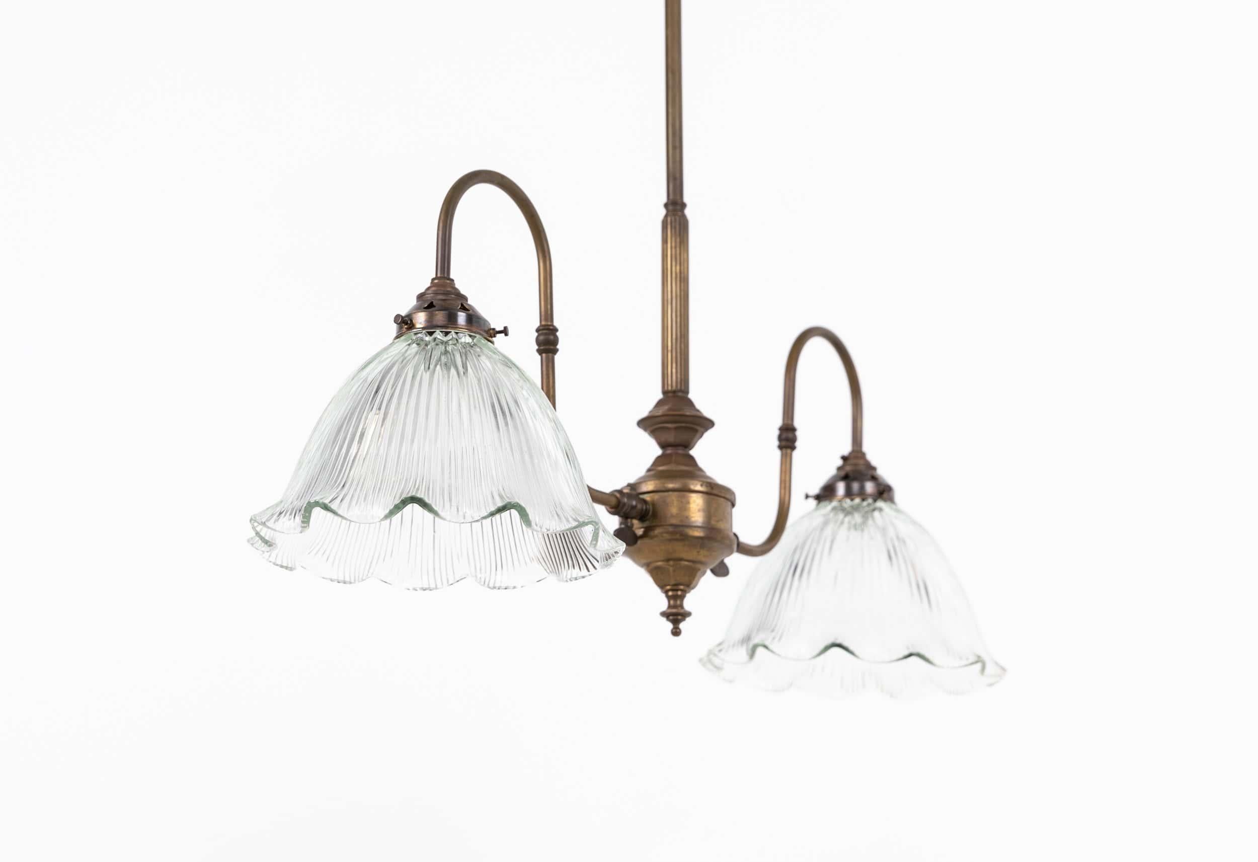 

An elegantly formed brass gasolier with prismatic glass shades. c.1920

Beautifully designed former gasolier, now converted to modern electrics. Complete with Holophane style shades and ceiling hook.
