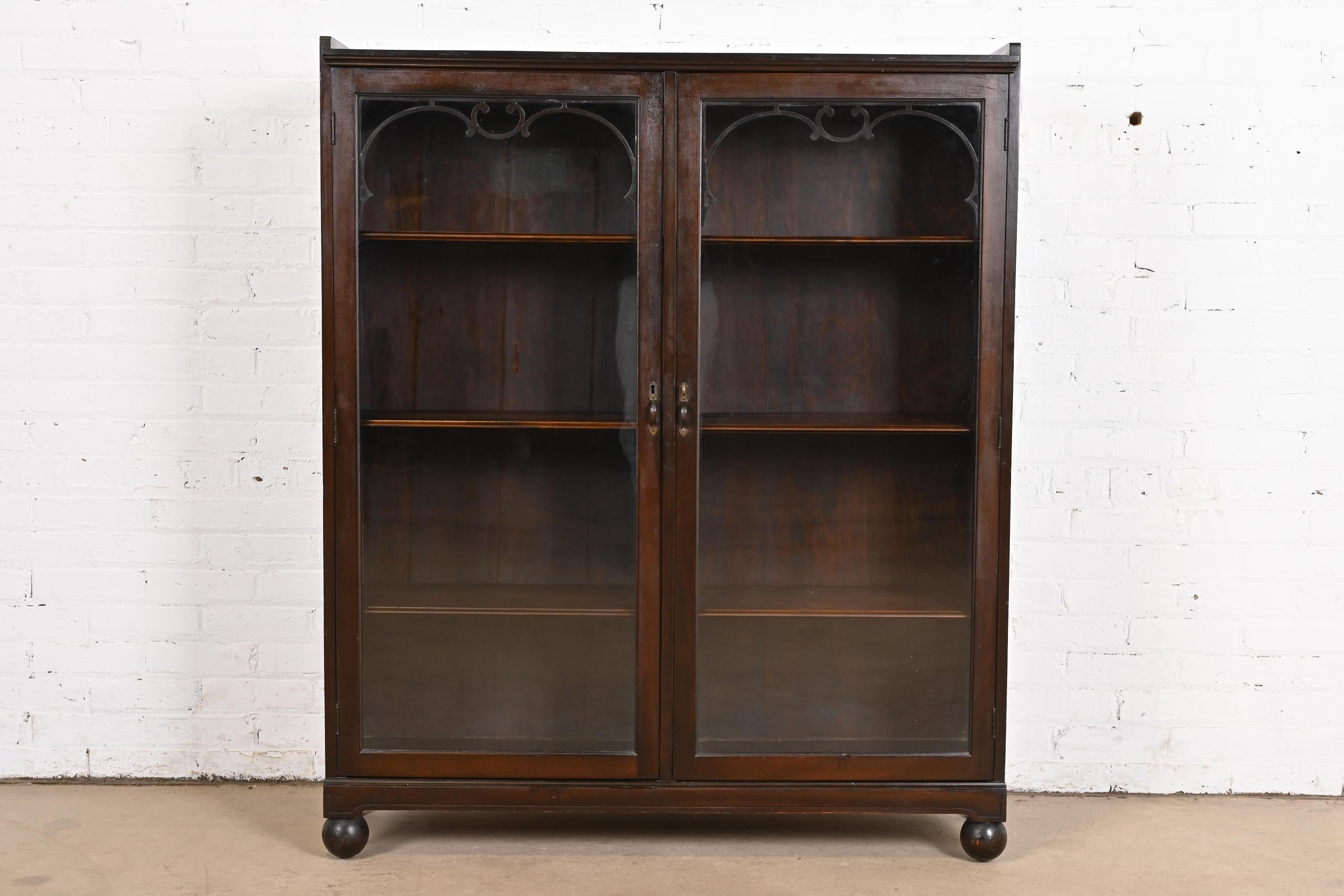 A gorgeous antique Arts & Crafts or Late Victorian carved mahogany glass front double bookcase

In the manner of R. J. Horner & Co.

USA, Circa 1900

Measures: 43.75