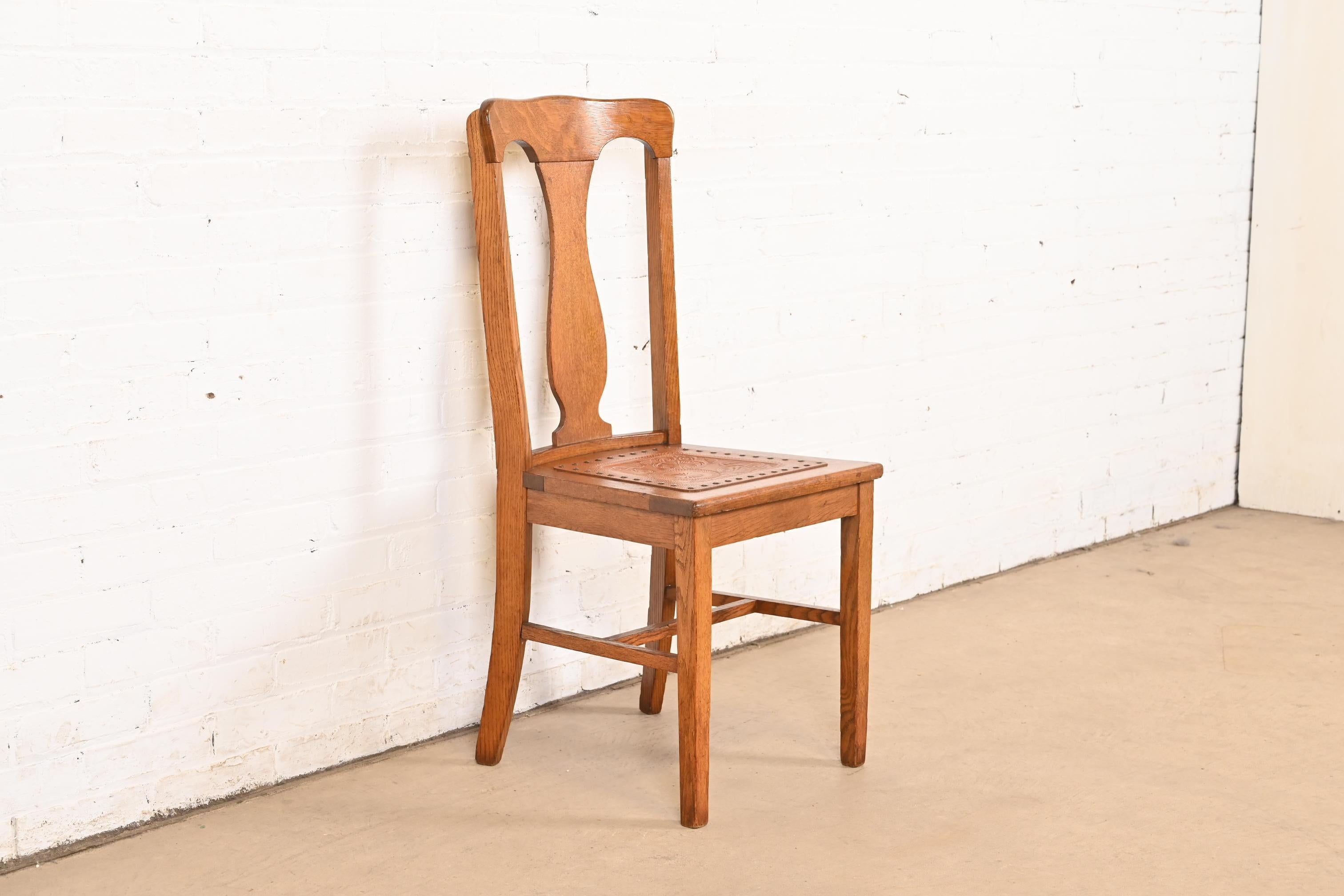 A gorgeous Mission or Arts & Crafts period dining chair or side chair

In the manner of Charles P. Limbert Co.

USA, Early 20th Century

Carved solid oak, with tooled leather seat.

Measures: 17