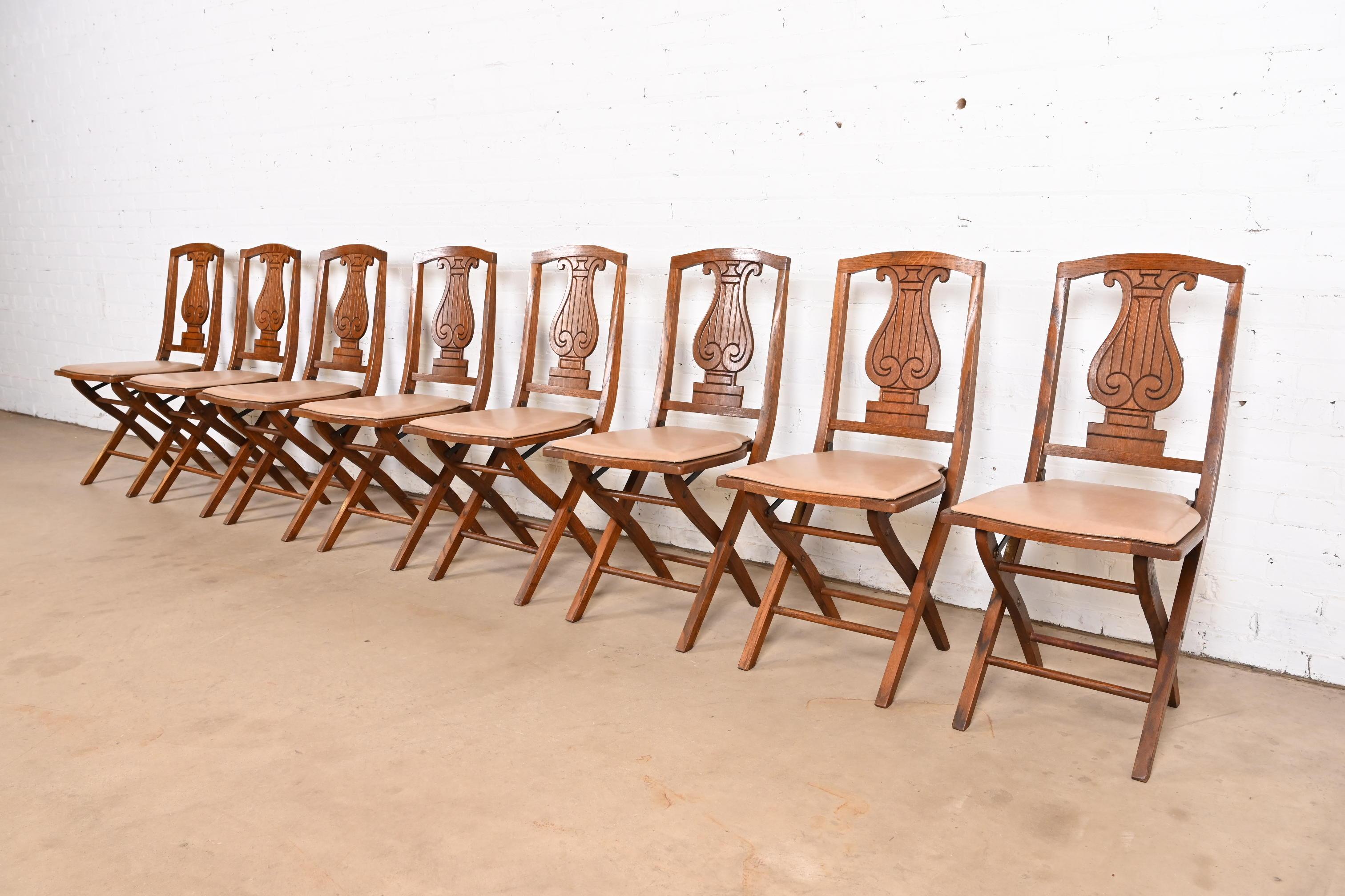 A rare and exceptional set of eight Arts & Crafts period lyre back folding dining chairs or side chairs

By Phoenix Chair Company

USA, Circa 1920s

Carved oak, with tan vinyl upholstery.

Measures: 16.75