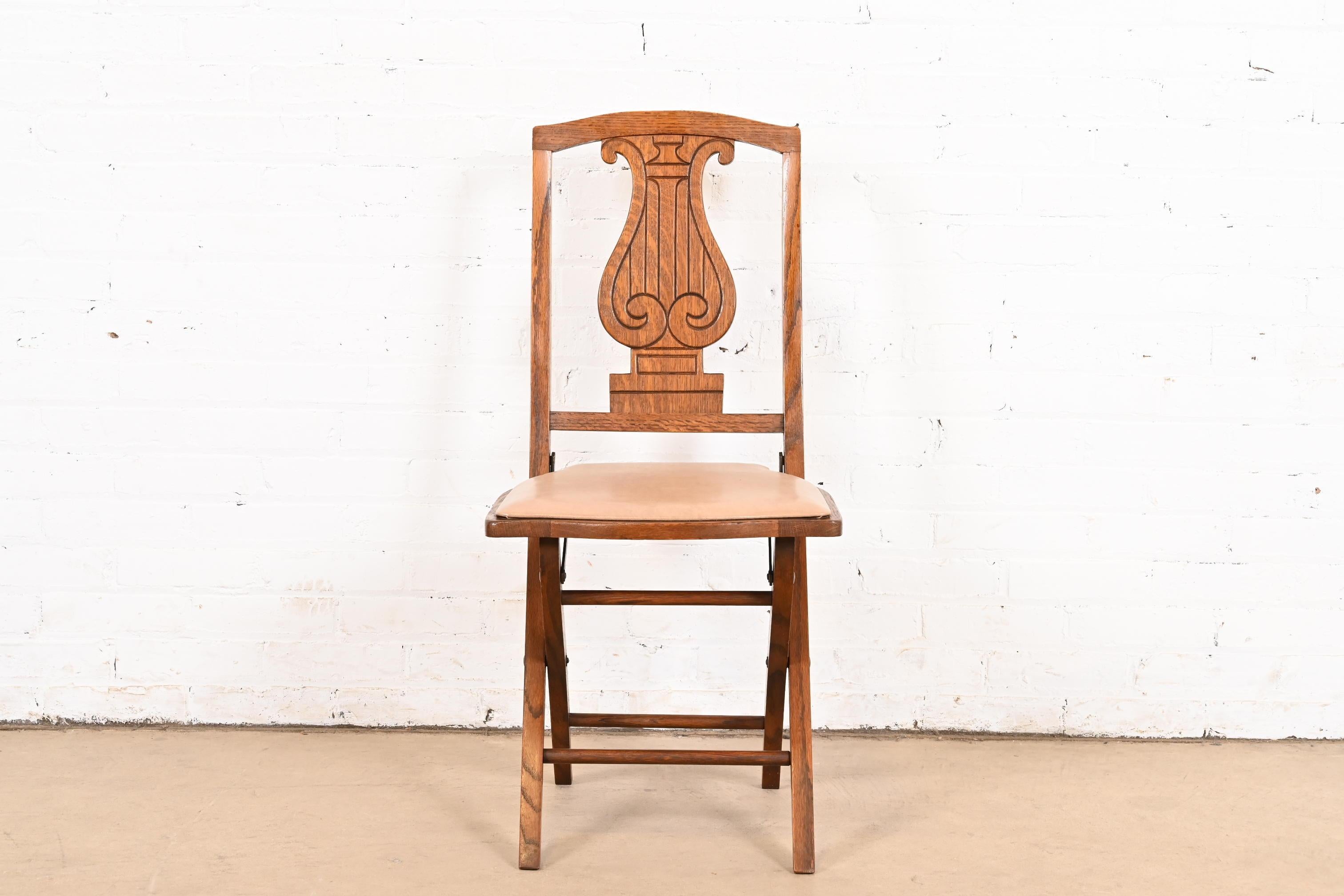 American Antique Arts & Crafts Carved Oak Lyre Back Folding Chair by Phoenix Chair Co. For Sale