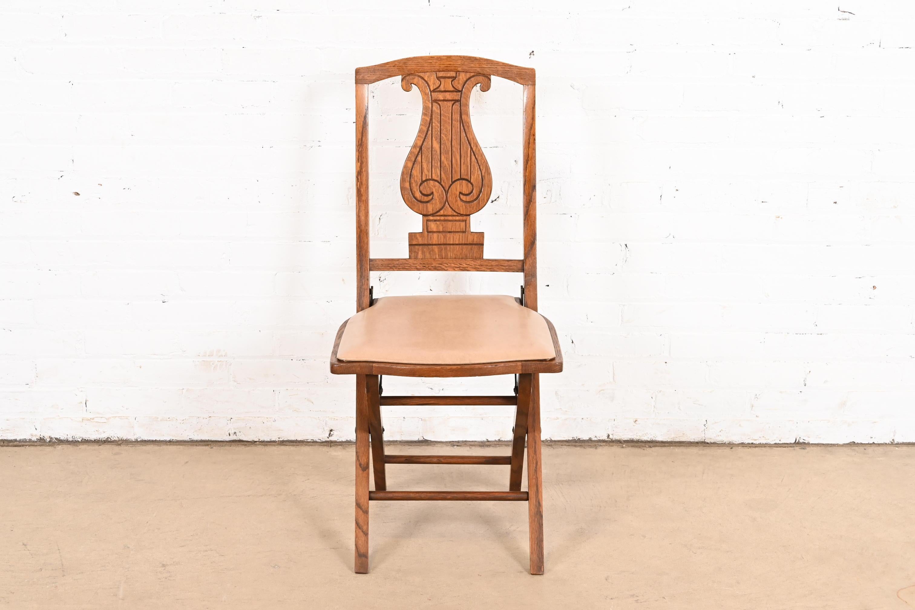 Antique Arts & Crafts Carved Oak Lyre Back Folding Chair by Phoenix Chair Co. In Good Condition For Sale In South Bend, IN
