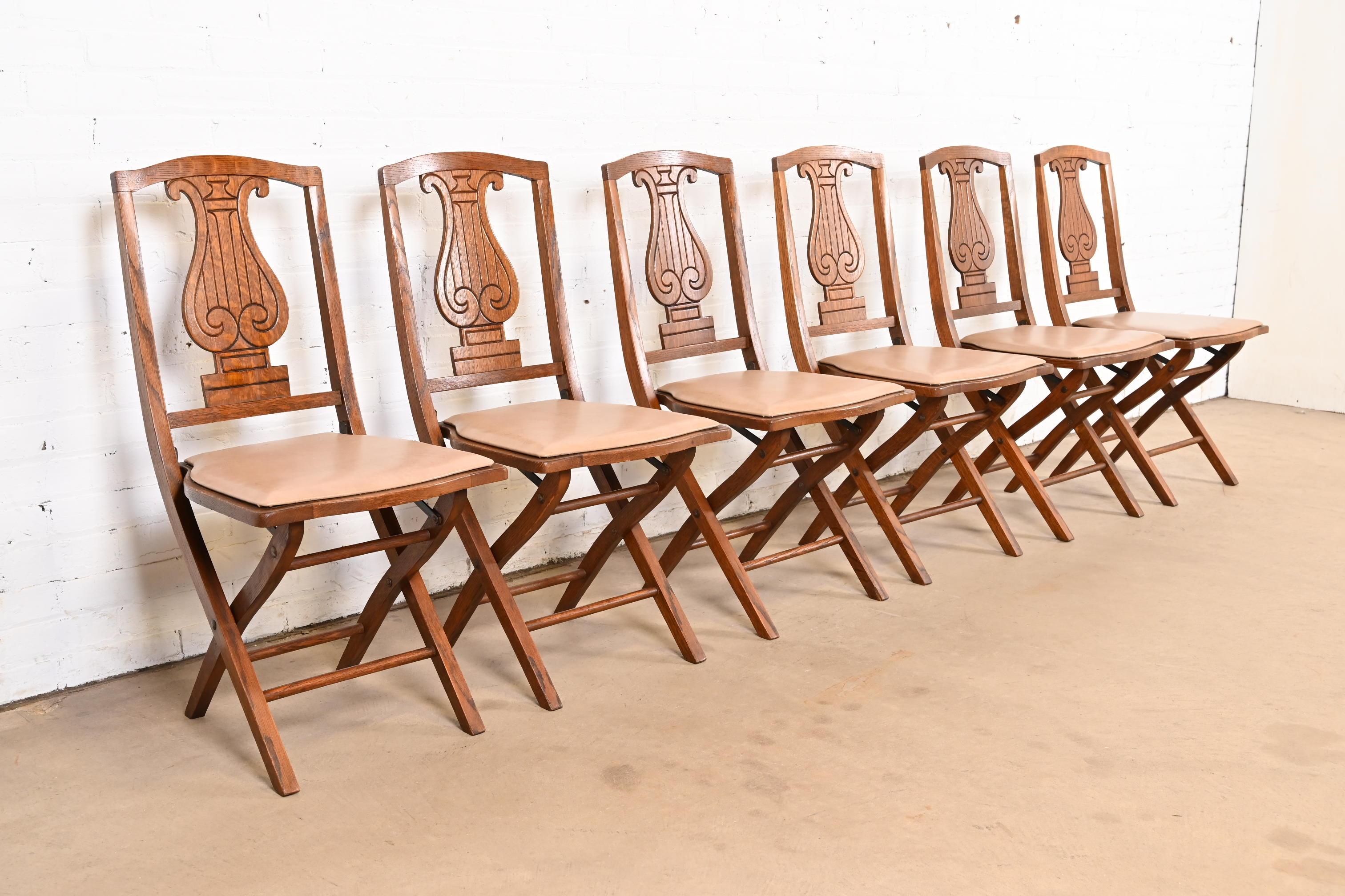 A rare and exceptional set of six Arts & Crafts period lyre back folding dining chairs or side chairs

By Phoenix Chair Company

USA, Circa 1920s

Carved oak, with tan vinyl upholstery.

Measures: 16.75