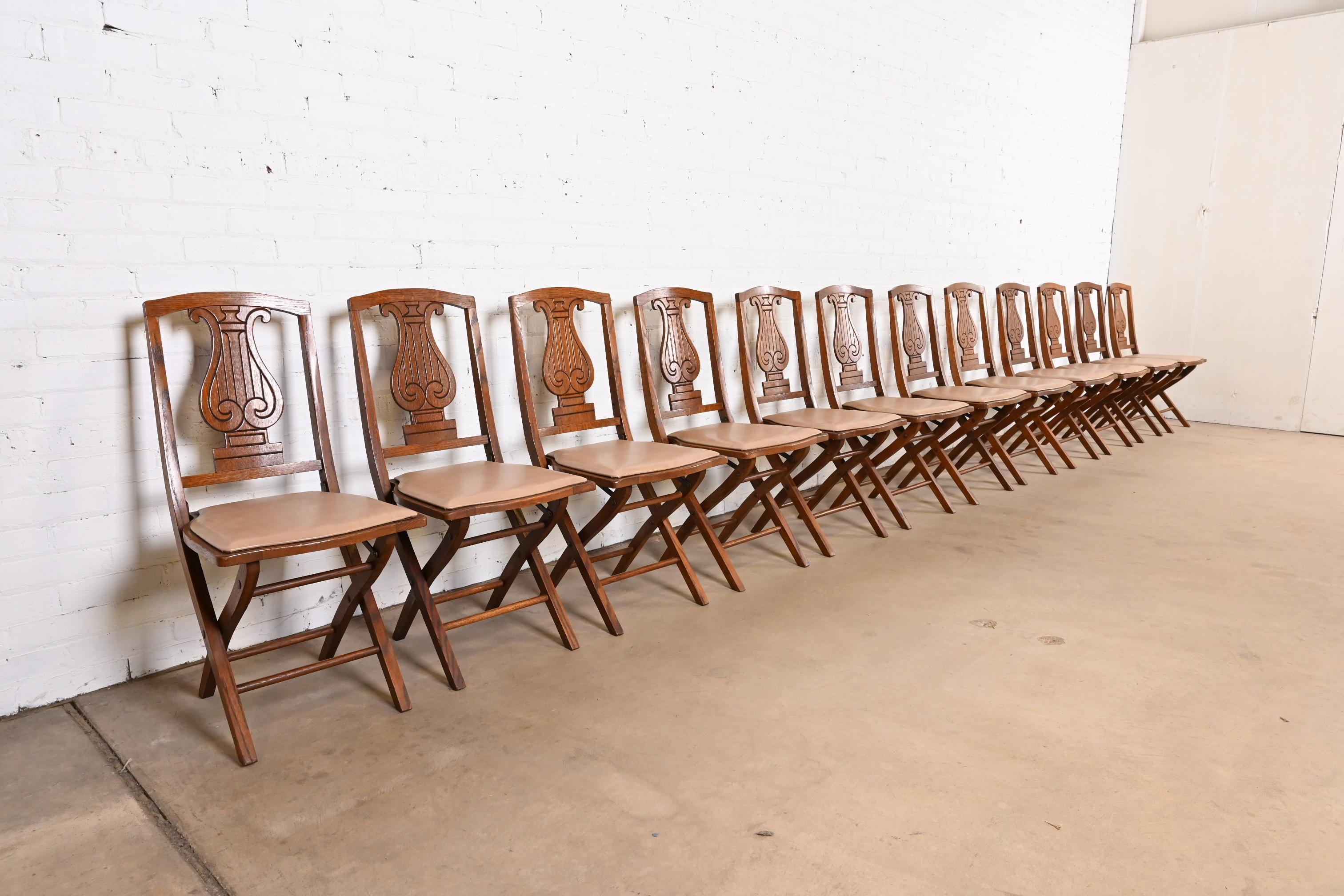 A rare and exceptional set of twelve Arts & Crafts period lyre back folding dining chairs or side chairs

By Phoenix Chair Company

USA, Circa 1920s

Carved oak, with tan vinyl upholstery.

Measures: 16.75