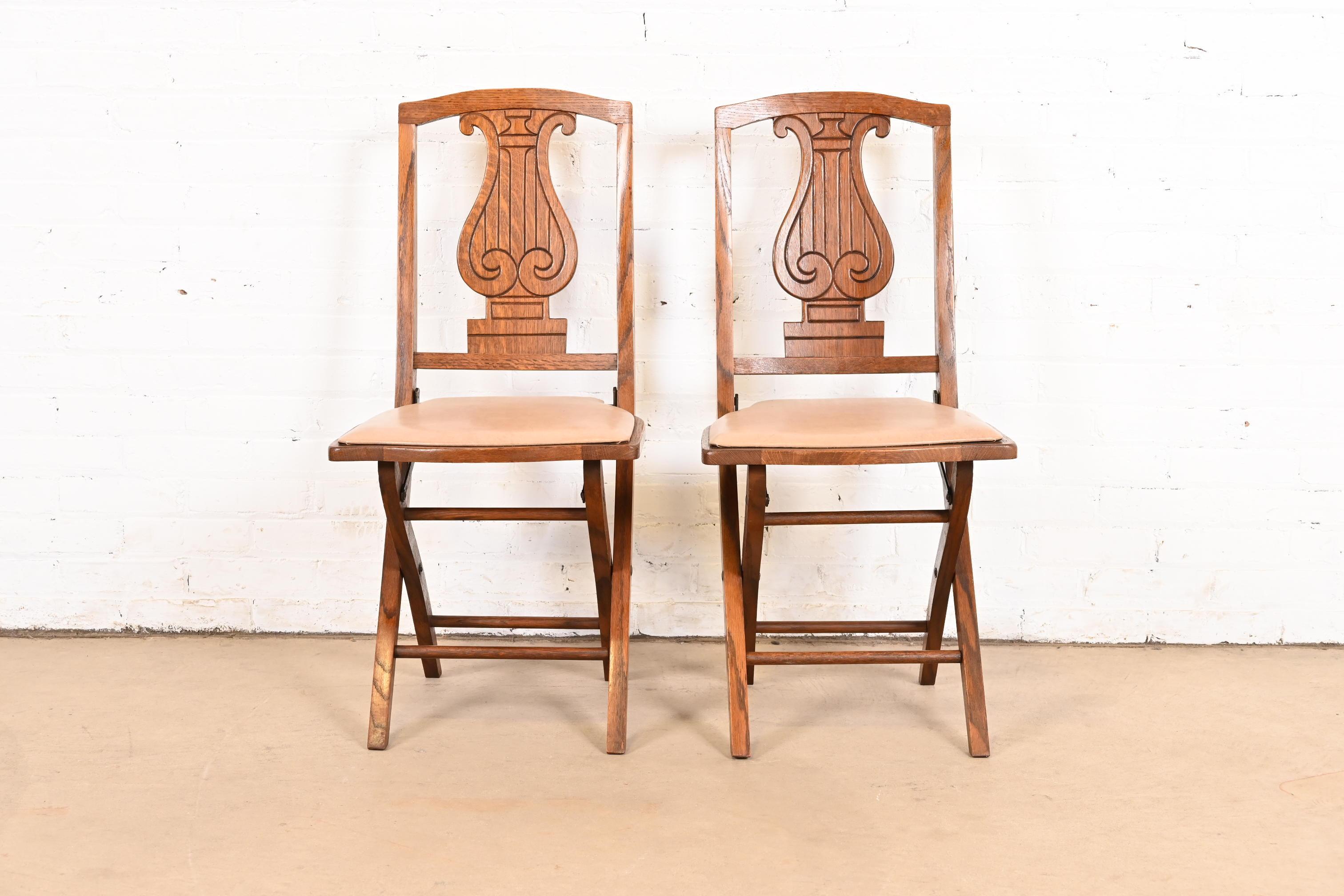American Antique Arts & Crafts Carved Oak Lyre Back Folding Chairs by Phoenix Chair Co. For Sale