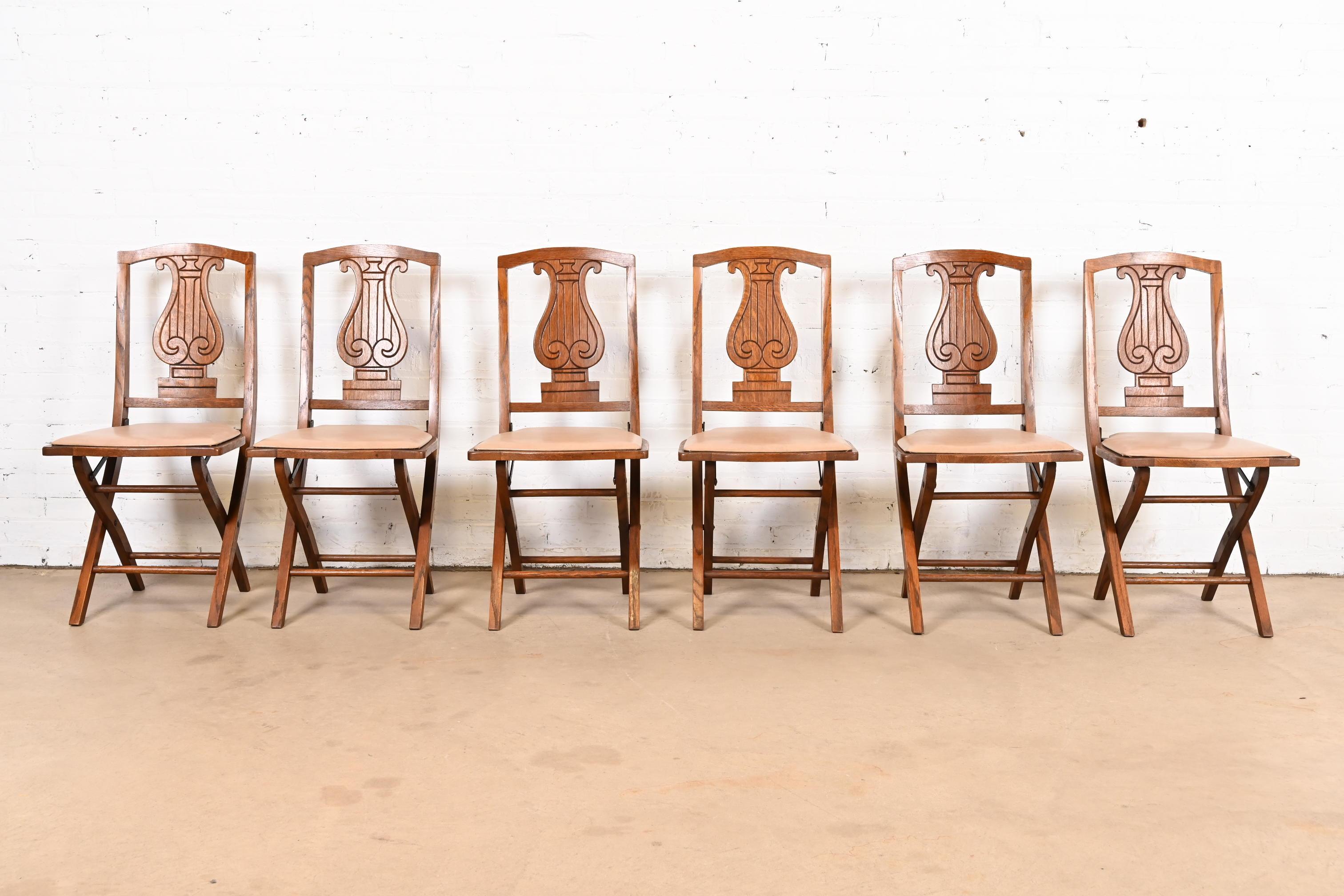 American Antique Arts & Crafts Carved Oak Lyre Back Folding Chairs by Phoenix Chair Co. For Sale