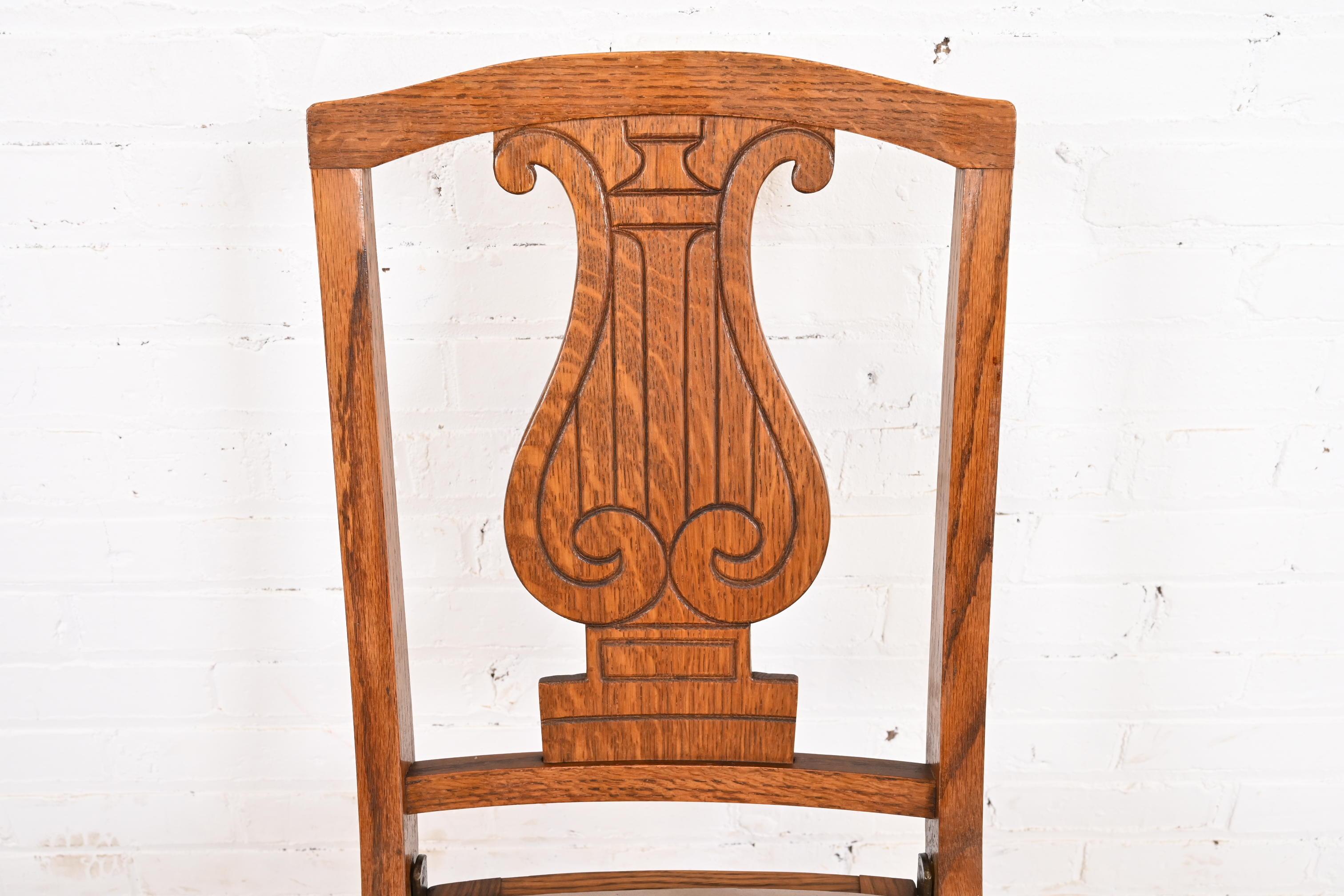Early 20th Century Antique Arts & Crafts Carved Oak Lyre Back Folding Chairs by Phoenix Chair Co. For Sale