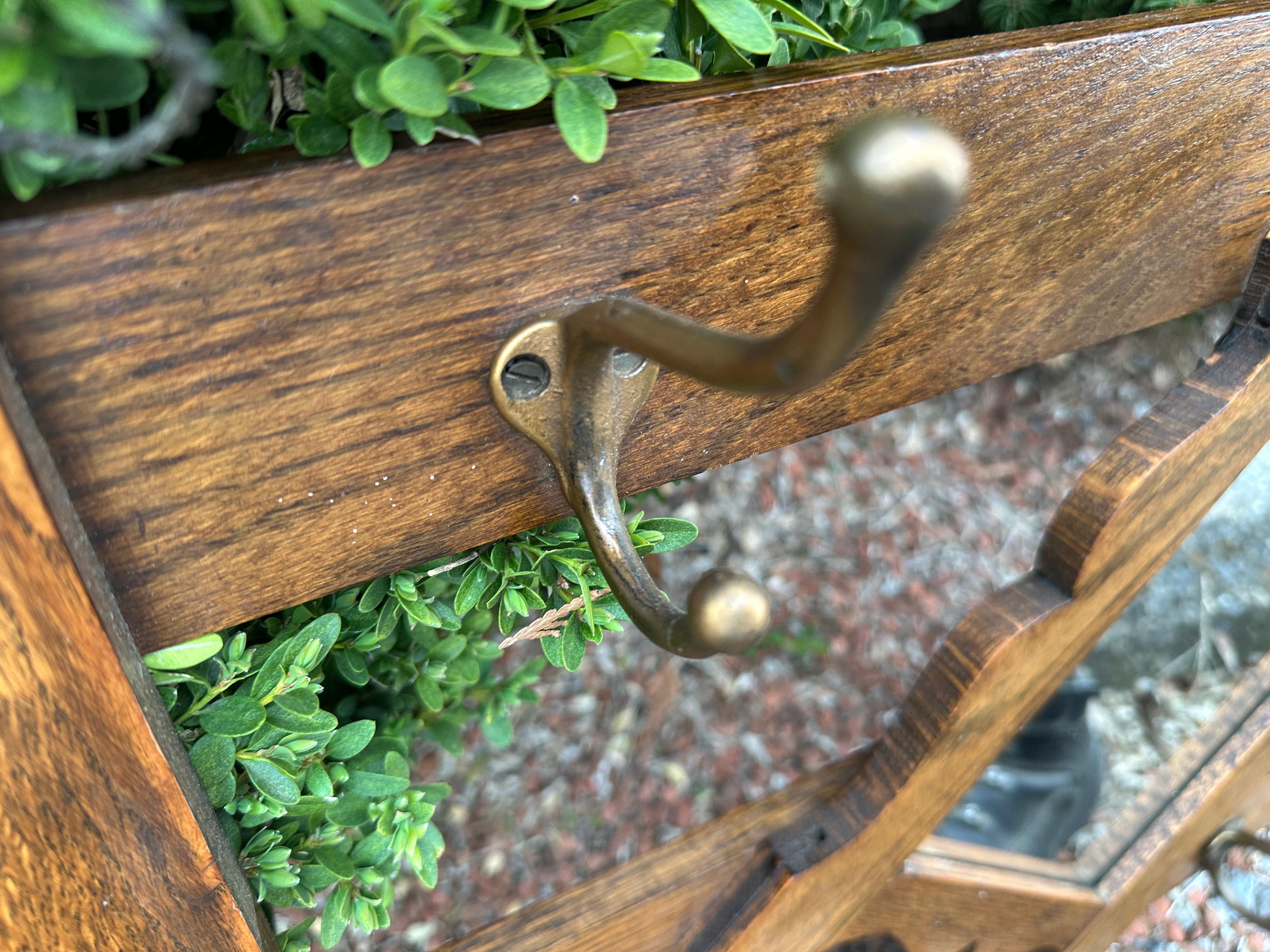 This is a nice Antique Arts & Crafts Wall-Mounted Coat Hanger with a center mirror.  There are 6 hooks for coats, etc. Made in the early 1900s, the piece is in very good condition.

W1732
LARGE SALE