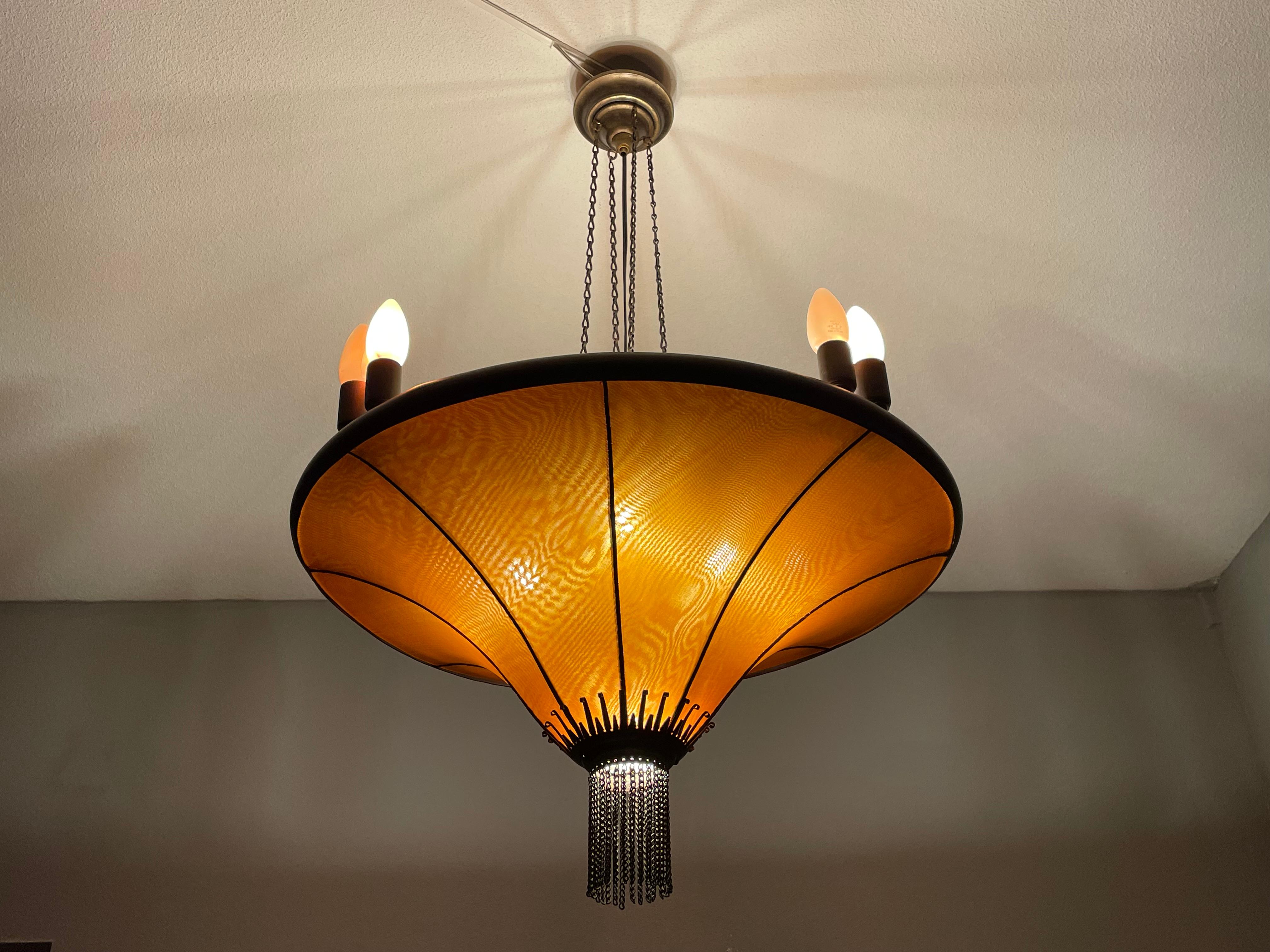 This striking and rare, 13-light chandelier has an amazing look and feel.

If you live or work in an Arts and Crafts or in an Art Deco building/interior and you are looking for a matching fixture to grace your living or work space then this very