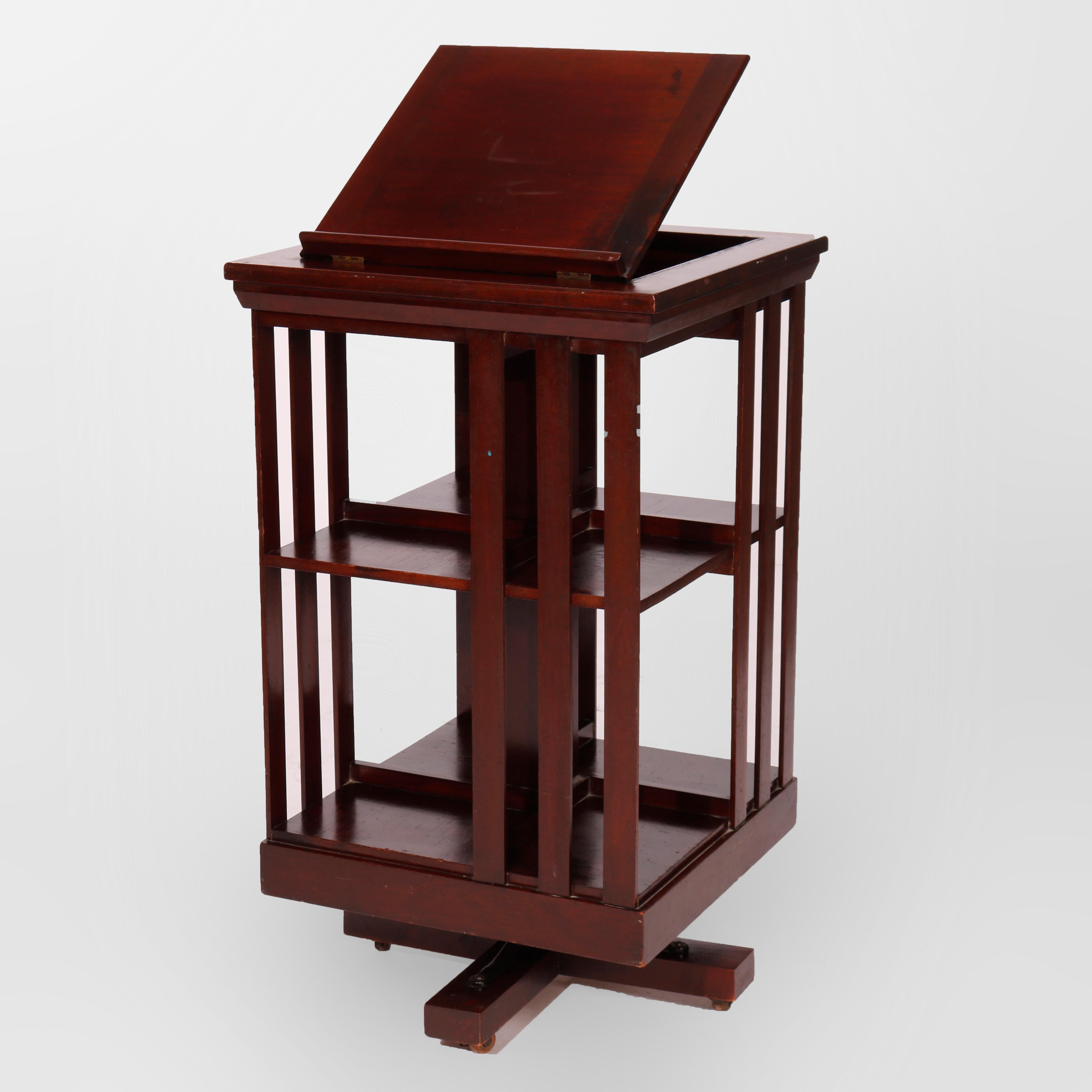 An antique Arts and Crafts Danner revolving bookcase offers mahogany construction with slat sides and lift-top presentation platform, c1900

Measures- 43.5''H x 20''W x 20''D.

Catalogue Note: Ask about DISCOUNTED DELIVERY RATES available to most