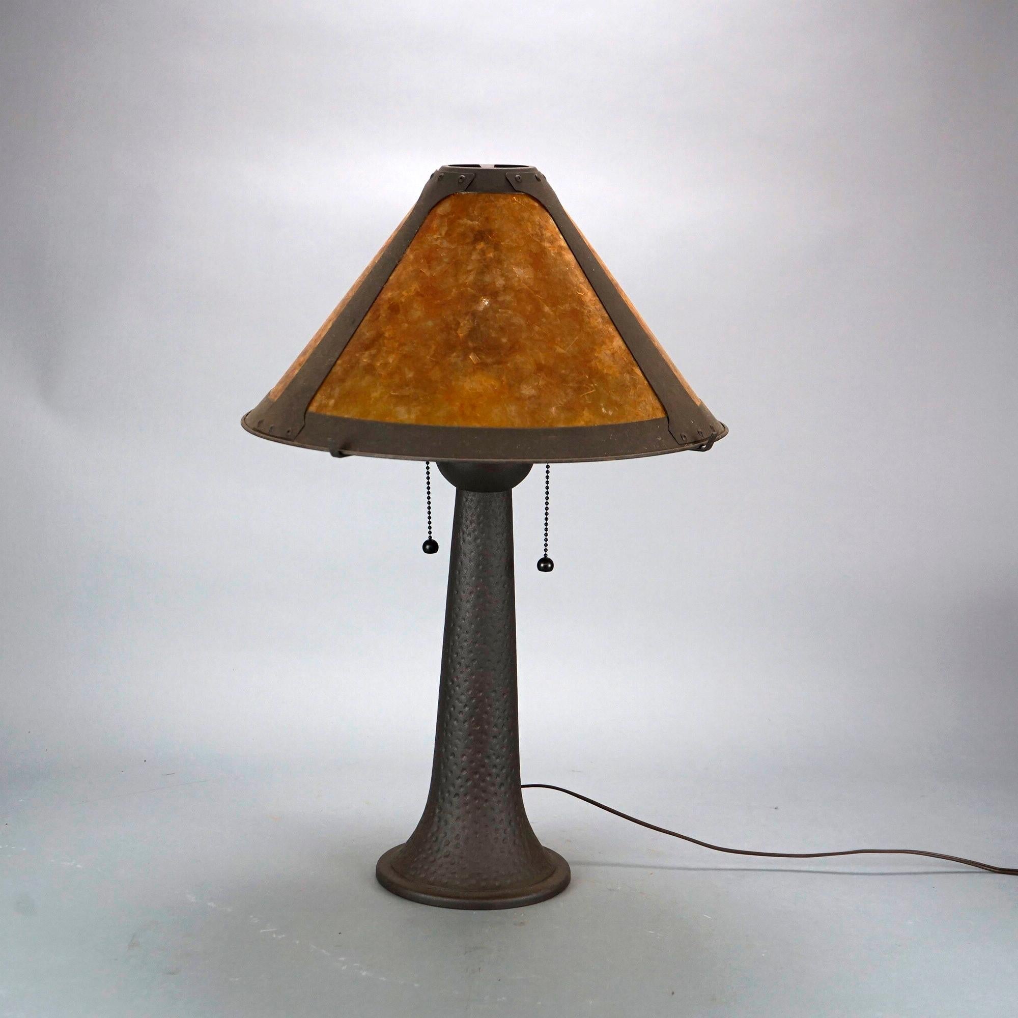 An antique Arts and Crafts table lamp in the manner of Dirk Van Erp offers conical mica shade over double socket bronzed metal base, c1920.

Measures- 24.25''H x 16''W x 16''D.

Catalogue Note: Ask about DISCOUNTED DELIVERY RATES available to most