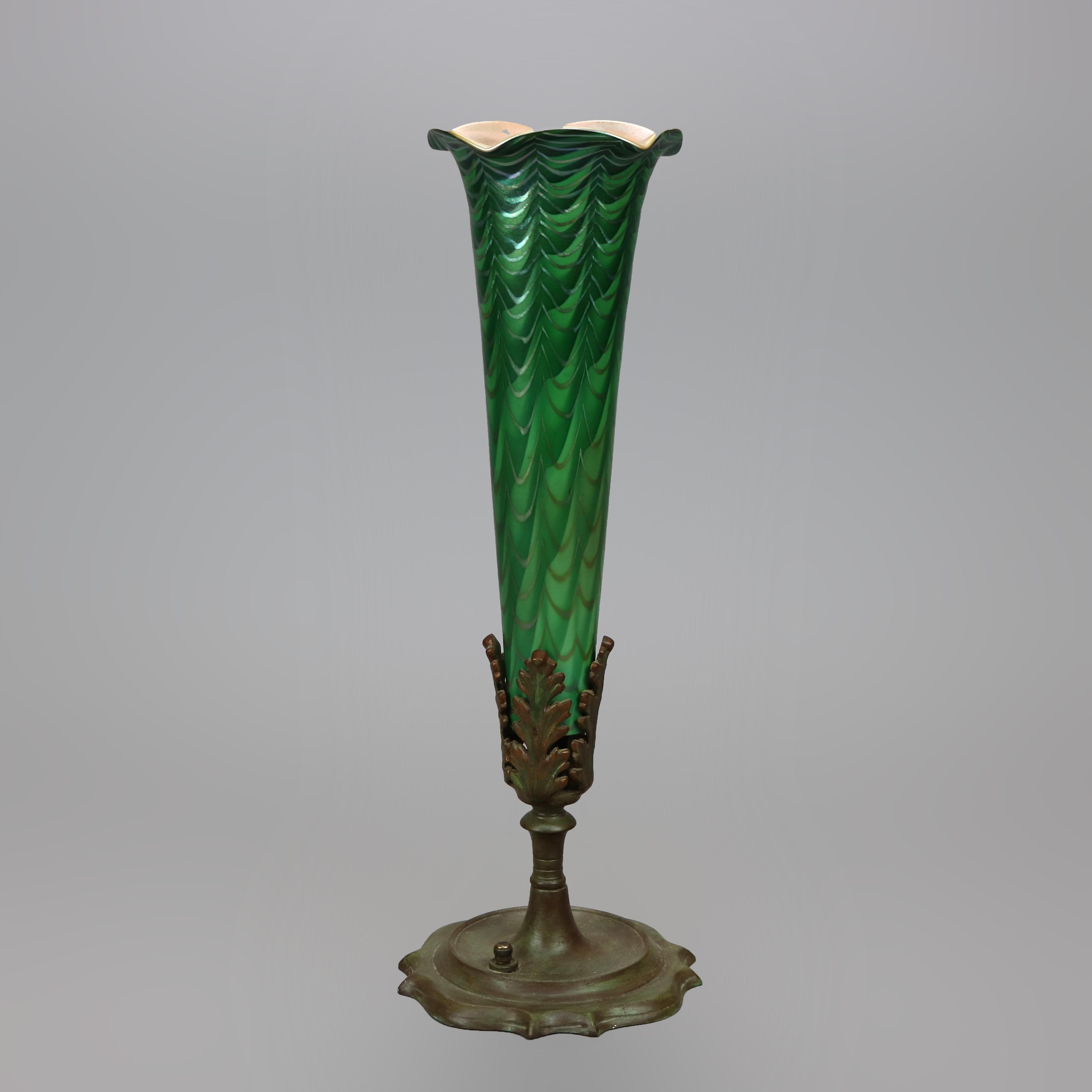 An Arts and Crafts table lamp by Durand offers flower form with flared art glass shade having green over marigold with ruffled rim, electrified and accommodates a 15w tube bulb, working, unsigned, c1930

Measures- 15.25''h x 5.25''w x