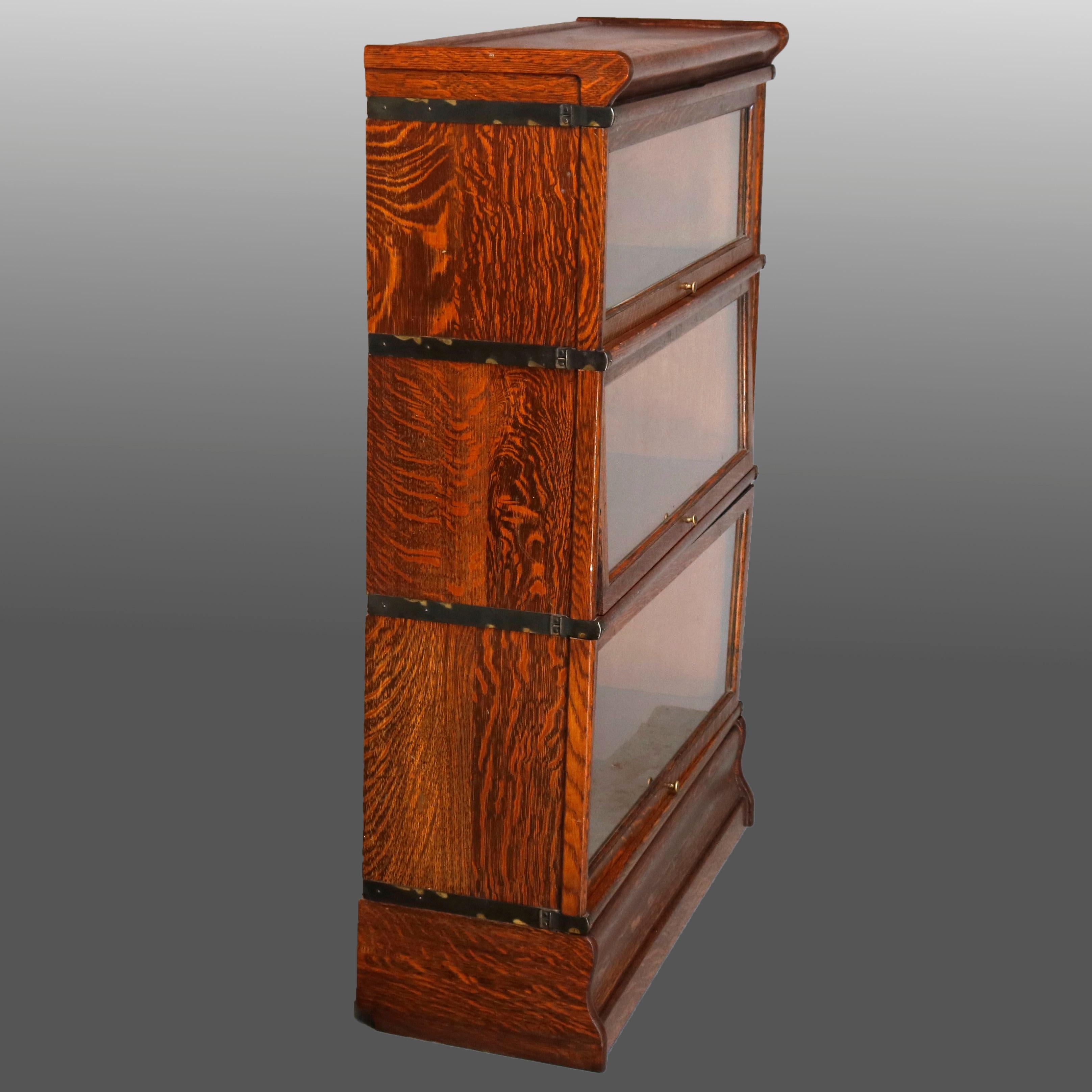 An Arts & Crafts Barrister three-stack bookcase by Globe Wernicke offers quarter sawn oak construction with pullout / pull-out glass doors, original labels as photographed, circa 1910.

Measures: 47.25