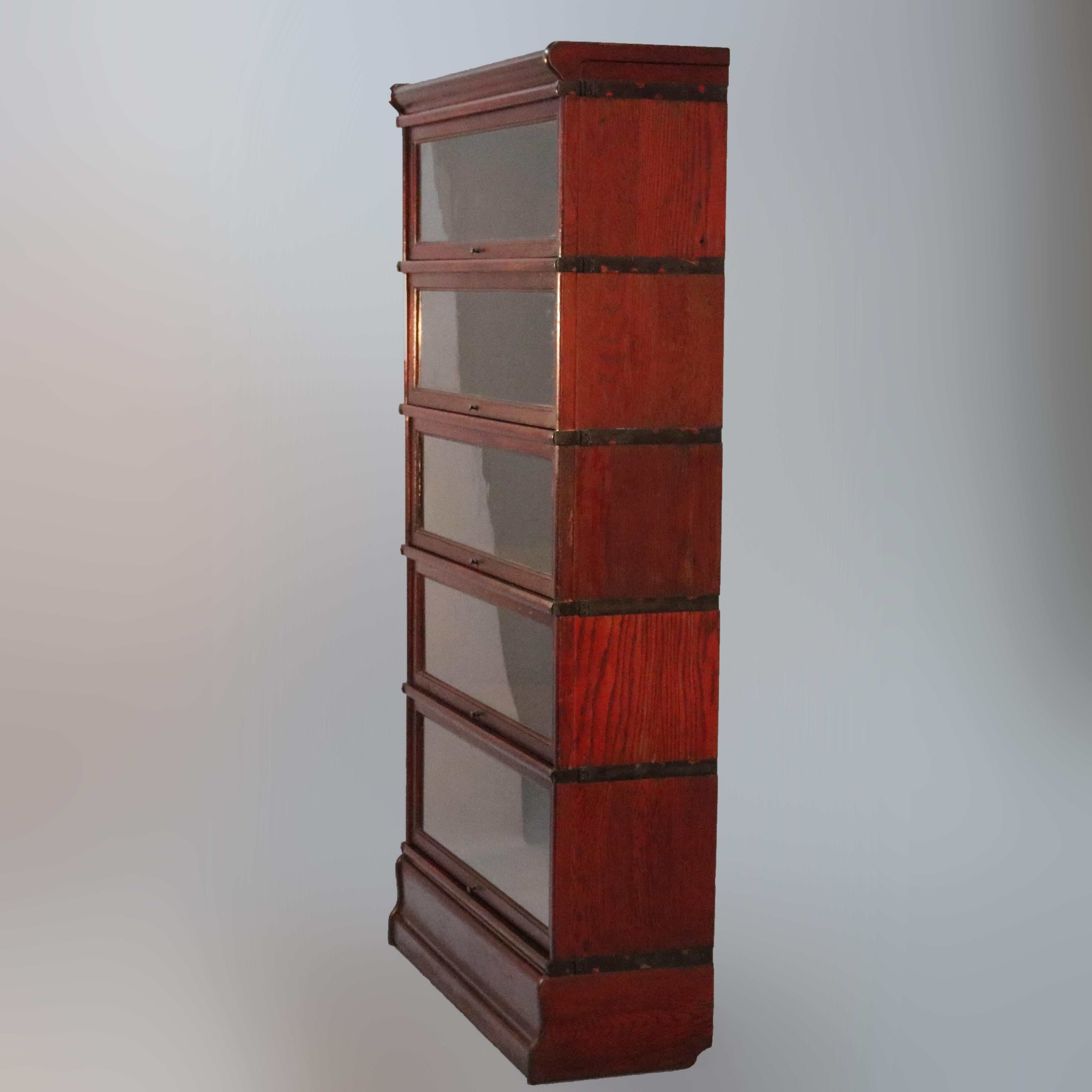 An antique Arts & Crafts Barrister bookcase by Globe Wernicke offers oak construction with five stacks having pullout / pull-out glass doors, original labels as photographed, circa 1910

Measures: 64.75