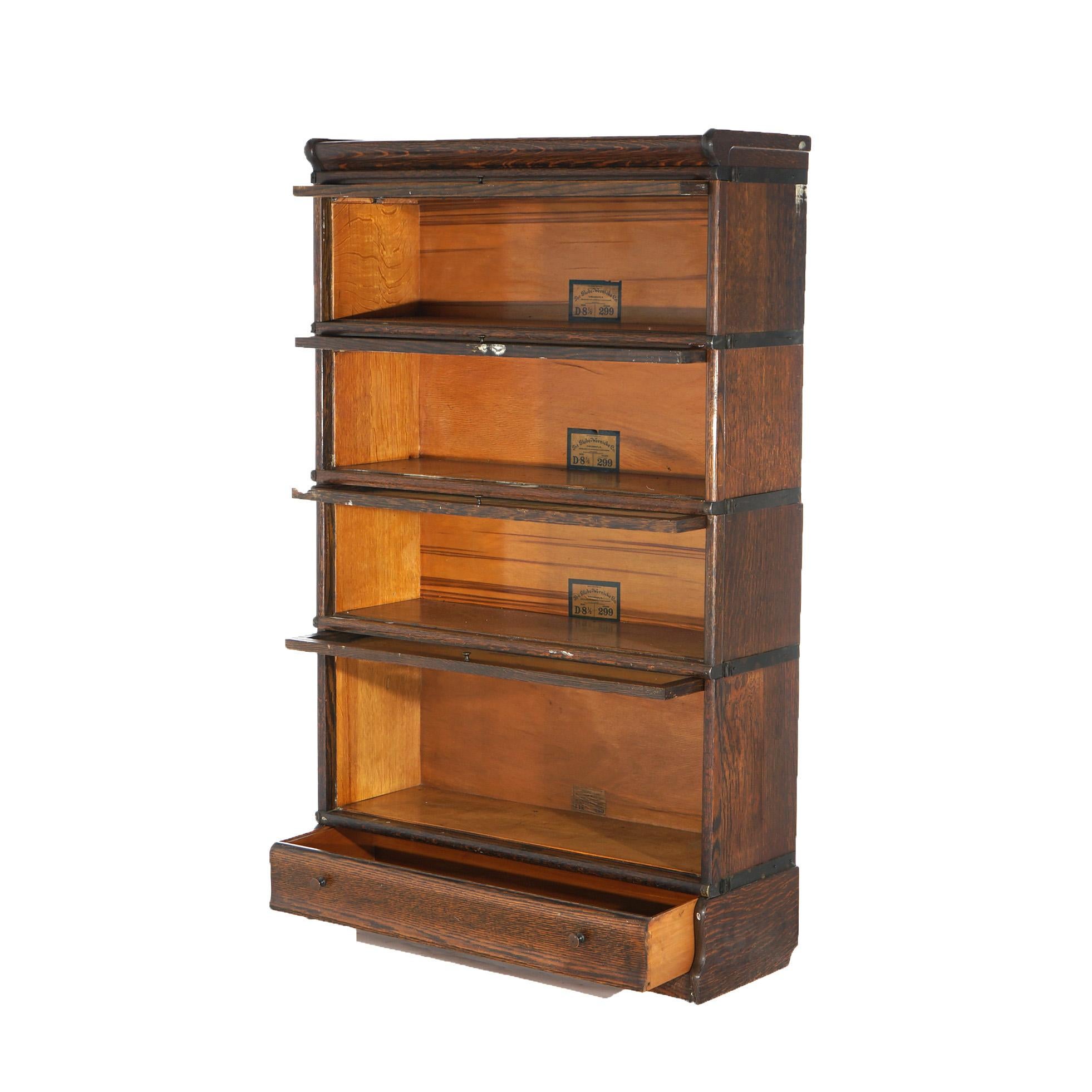 An antique Arts and Crafts barrister bookcase by Globe Wernicke offers quarter sawn oak construction with four stacks, each having pullout glass doors, raised on ogee base, maker labels as photographed, c1910

Measures - Overall 56.25''H x 34''W x