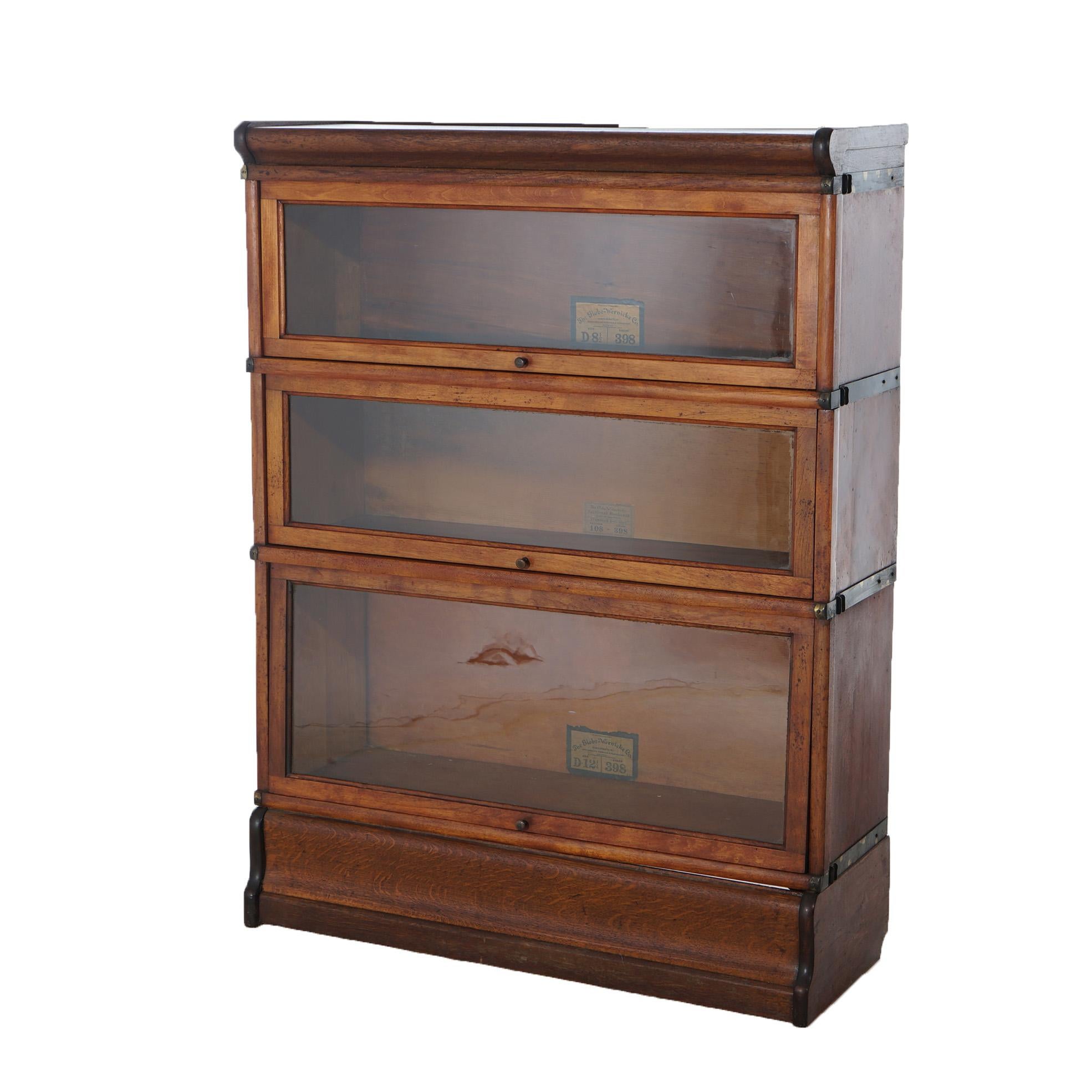 ***Ask About Discounted In-House Shipping***
An antique Arts and Crafts barrister bookcase by Globe Wernicke offers mahogany construction with three stacks, each having pullout glass doors and raised on an ogee base, maker label as photographed,