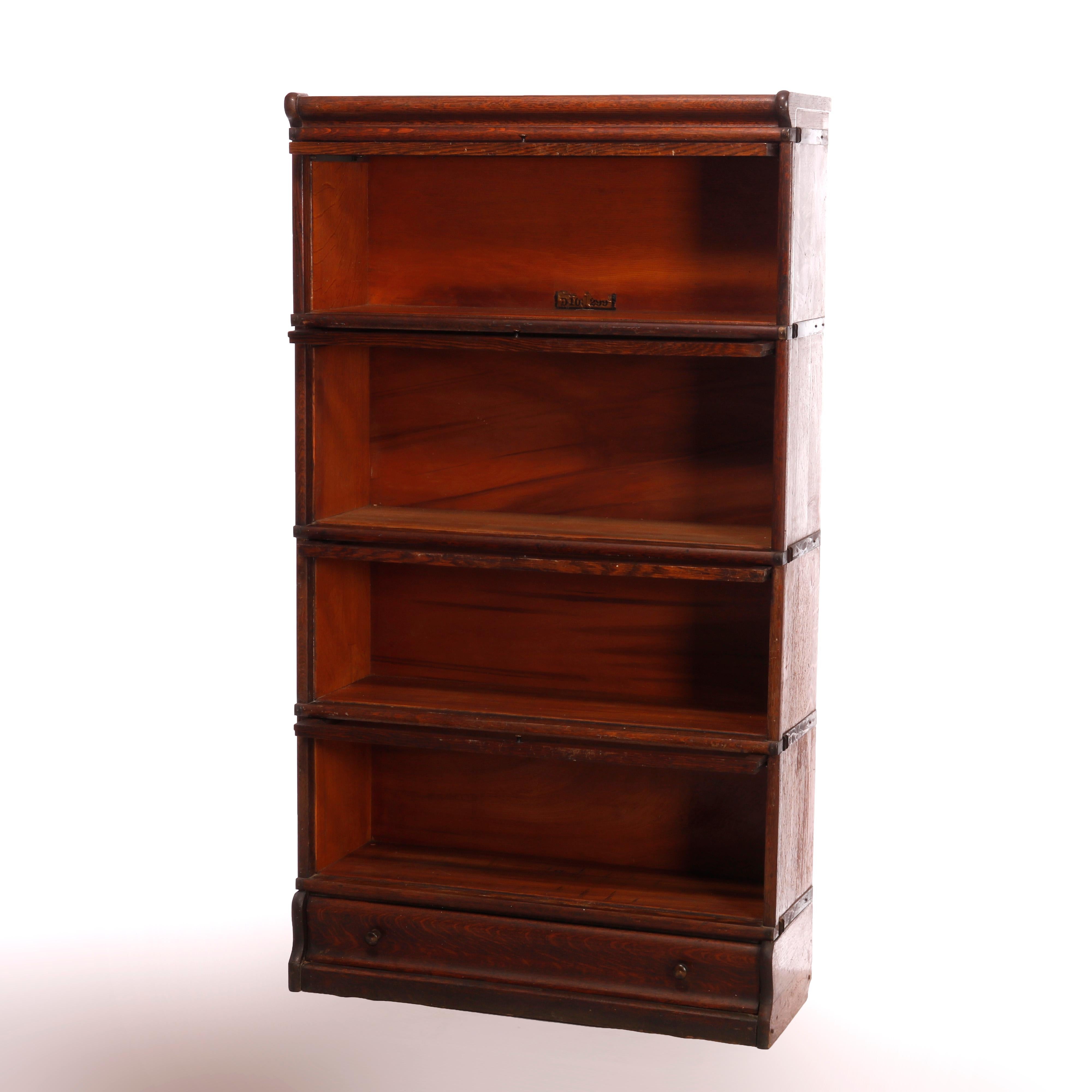 An antique Arts and Crafts Barrister bookcase by Globe Wernicke offers oak construction with four stacks, each having pull out glass doors and seated on ogee base, maker label as photographed, c1910

Measures - 61.25''H x 34''W x