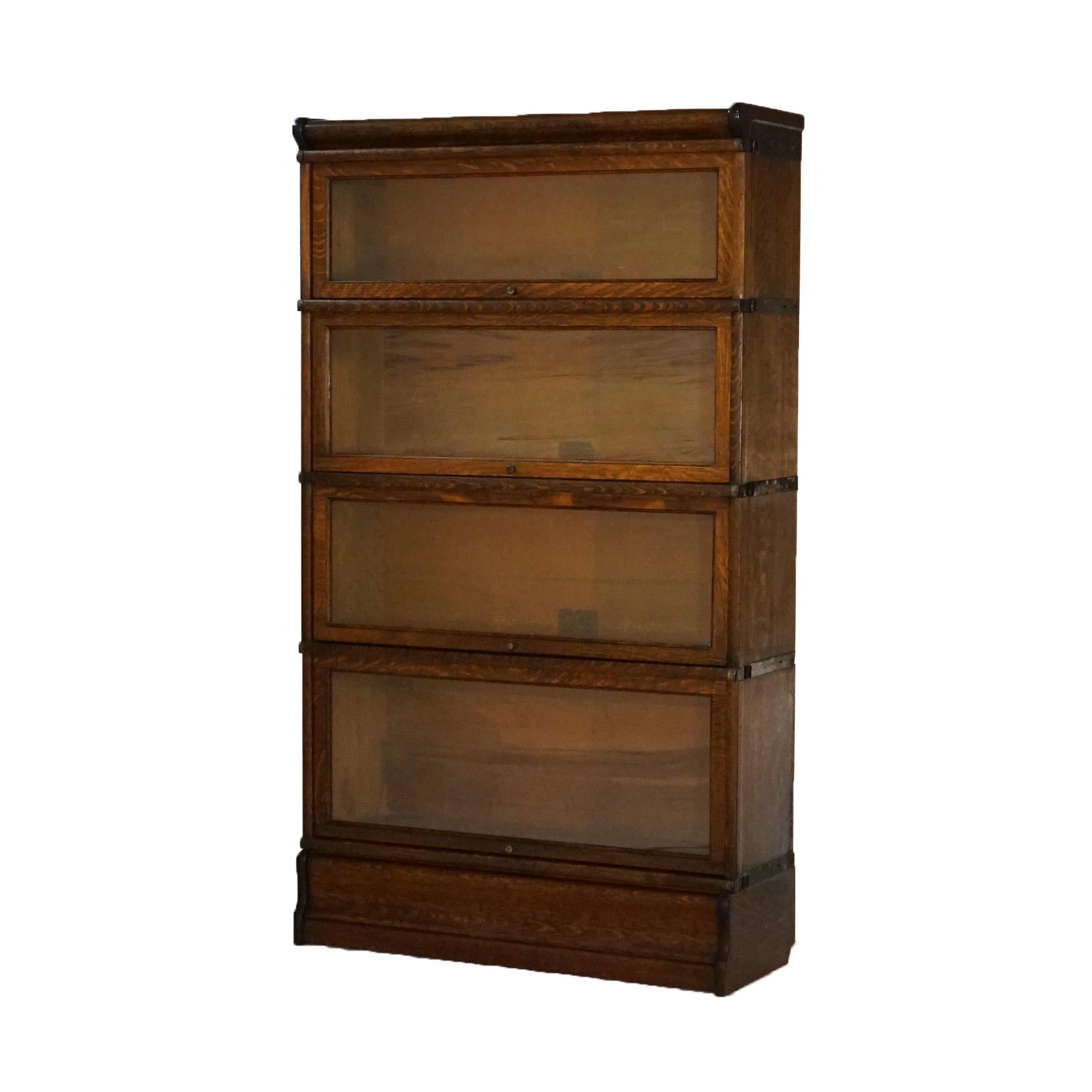***Ask About Reduced In-House Shipping Rates - Reliable Service & Fully Insured***
An antique Arts and Crafts barrister bookcase by Globe Wernicke offers oak construction with four stacks, each having pull out glass doors, raised on ogee base, maker