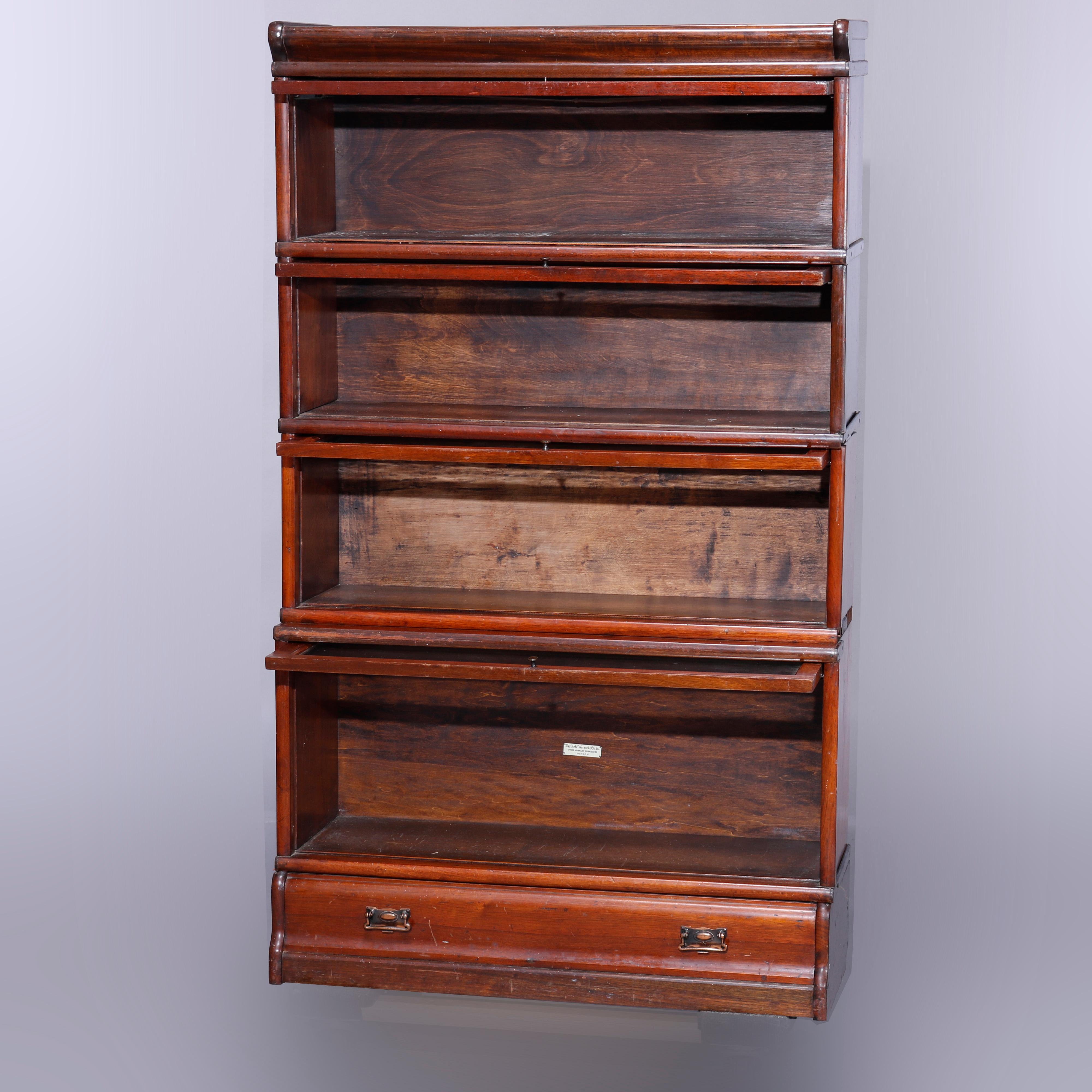 An antique Arts & Crafts barrister bookcase in the manner of Globe Wernicke offers mahogany construction with four stacks (three uniform over one oversized), seated on ogee base with drawer, circa 1910
4 Stack Barrister Bookcase Circa 1910

Measures