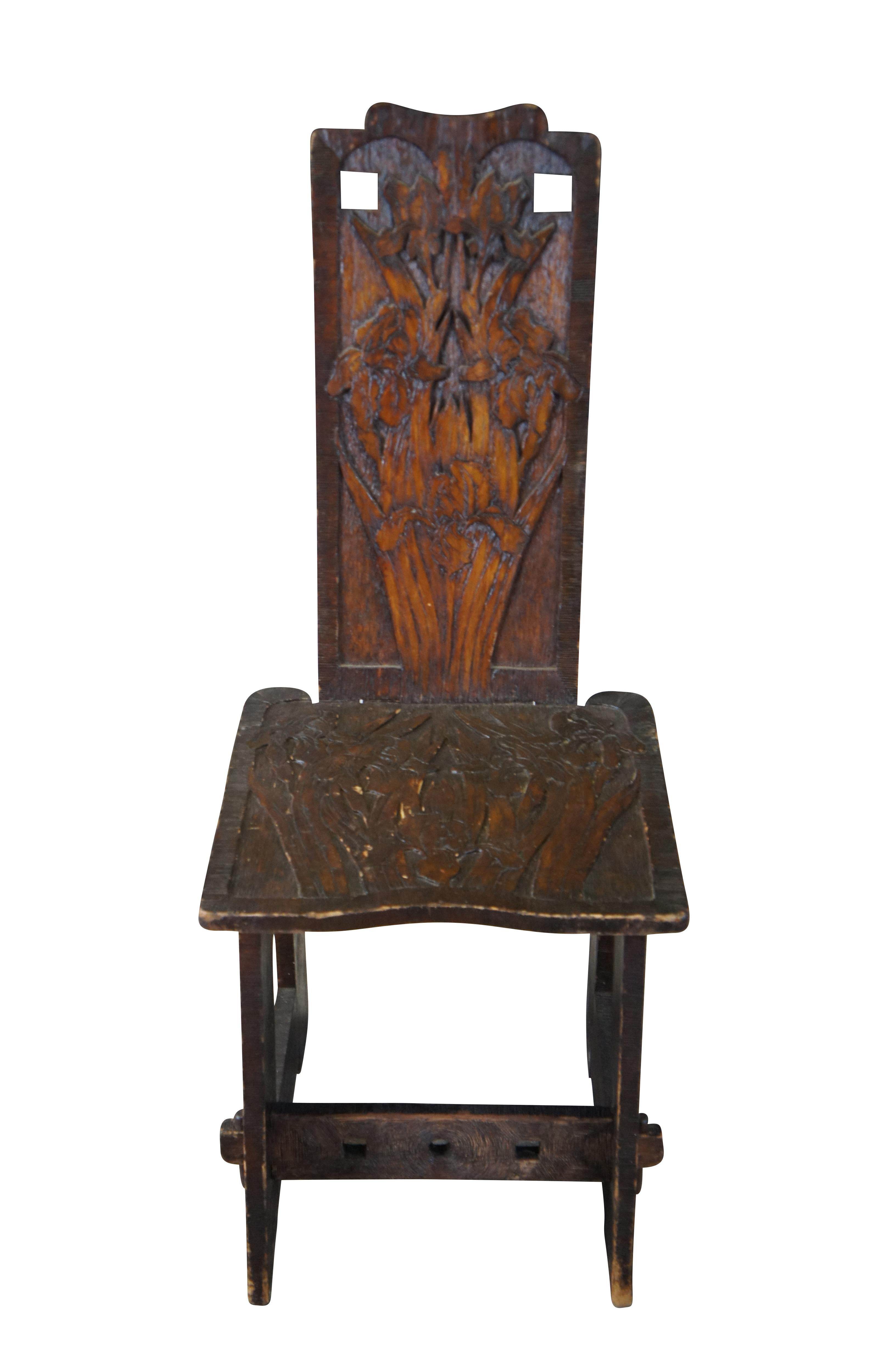 An antique early 20th century Arts & Crafts Pyrography Chair.  The chair is made from oak and has a Chrysanthemum carved into the back.  The chair is a knockdown chair and is held together via tenons.  

Pyrography, also known as wood burning, is an