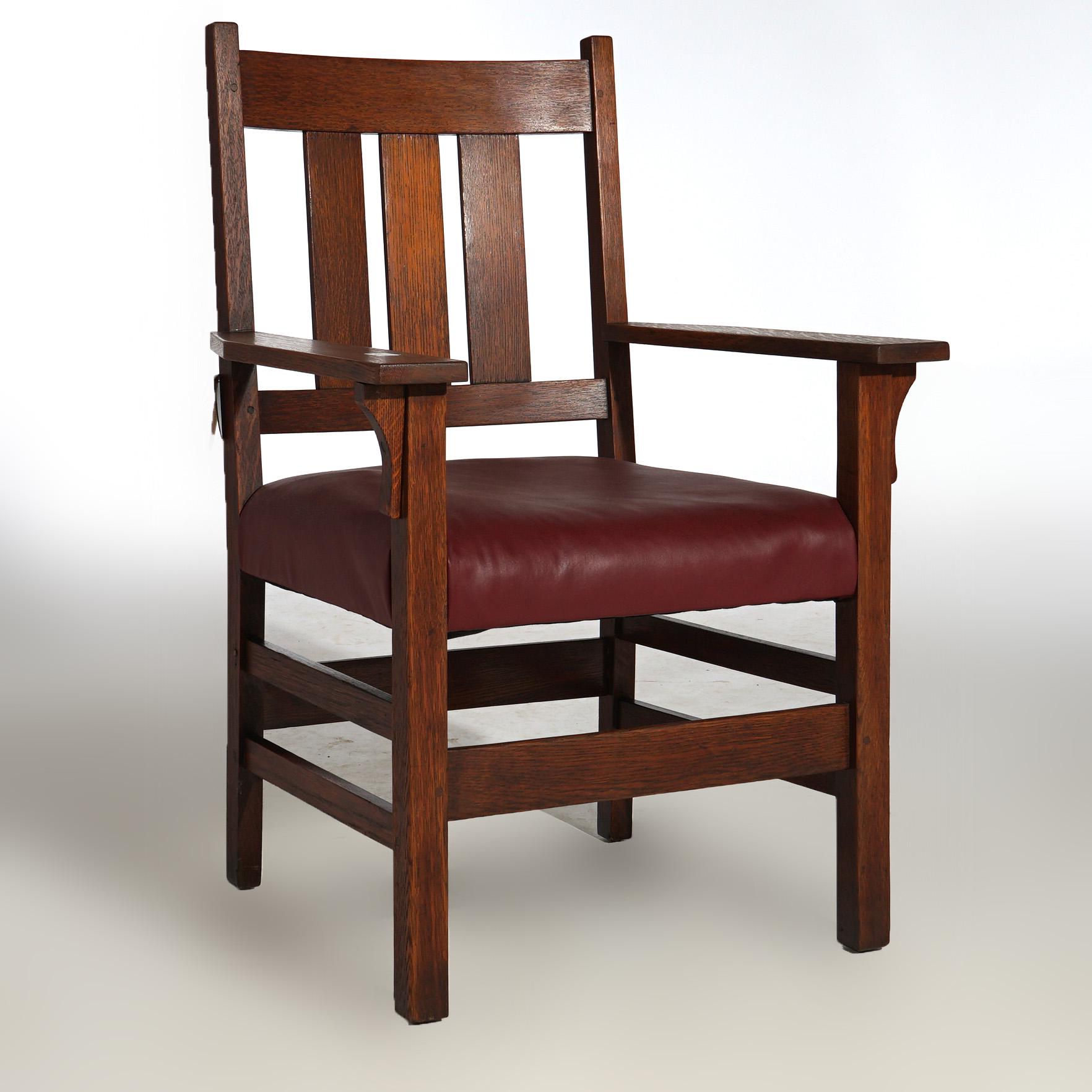 An antique Arts and Craft armchair by Gustav Stickley offers oak construction with slat back, signed, c1910

Measures - 38.75