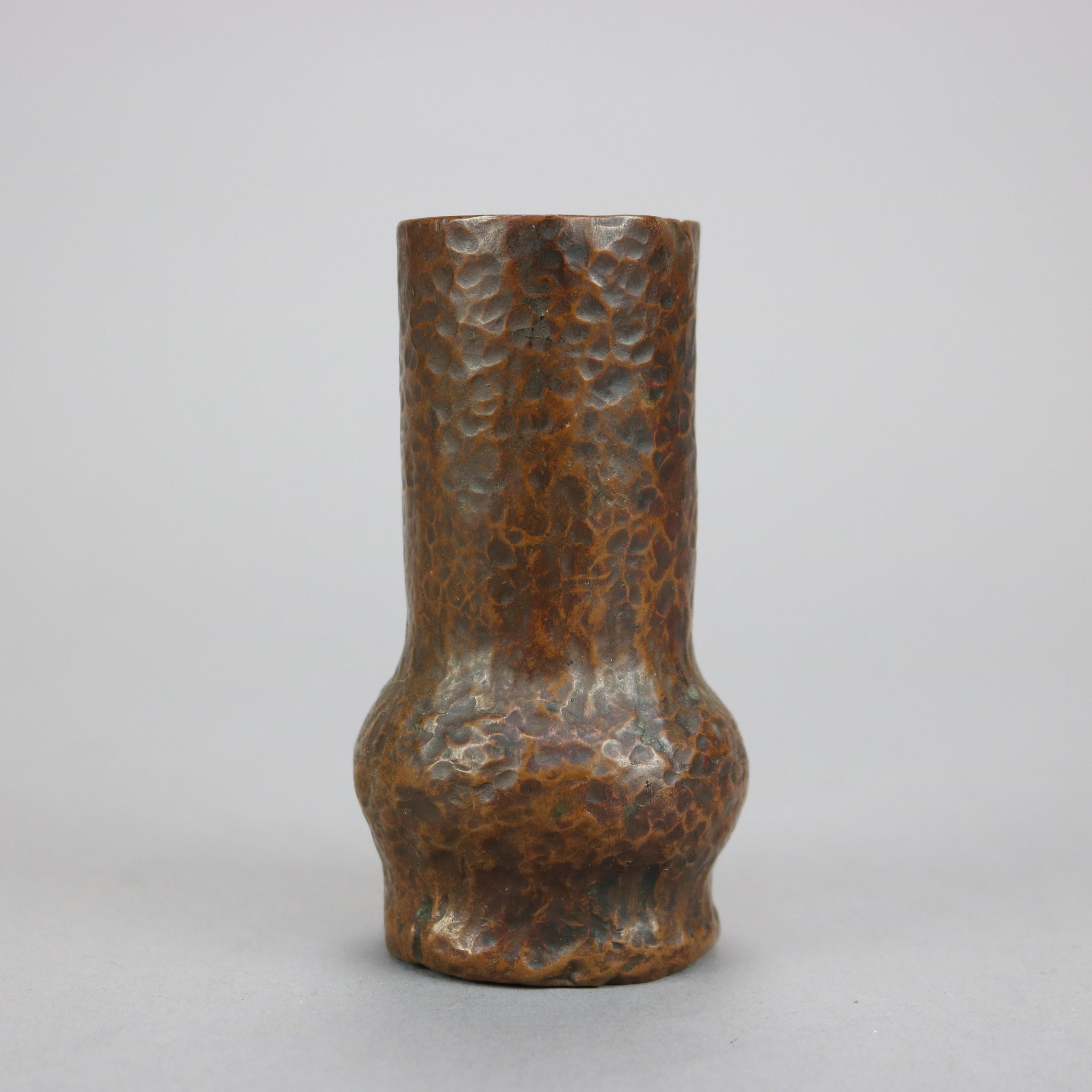 An Arts & Crafts cabinet vase offers hand hammered copper construction in cylinder form, c1910

Measures - 4''H X 2.25''W X 2.25''D.

Catalogue Note: Ask about DISCOUNTED DELIVERY RATES available to most regions within 1,500 miles of New York.