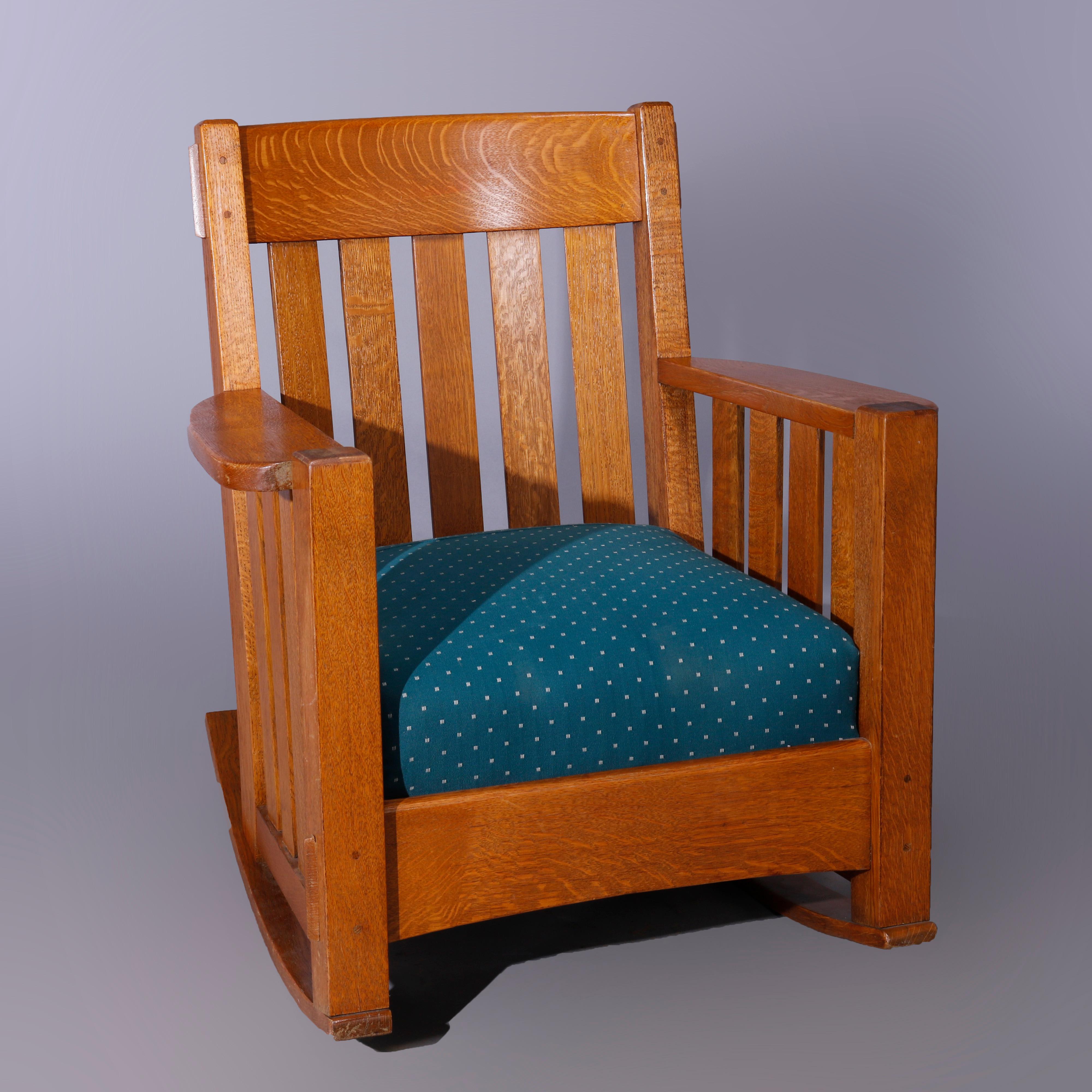 An antique Arts & Crafts Harden mission oak rocker offers slat back and sides with cushion seat, c1910

Measures - 34'' H x 30.5'' W x 29'' D; 17